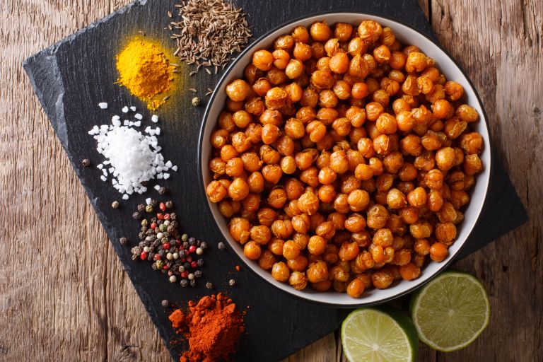 Chickpeas next to limes and seasoning