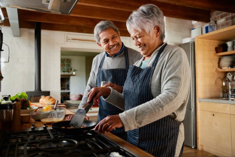 Older couple cooking in the kitchen together