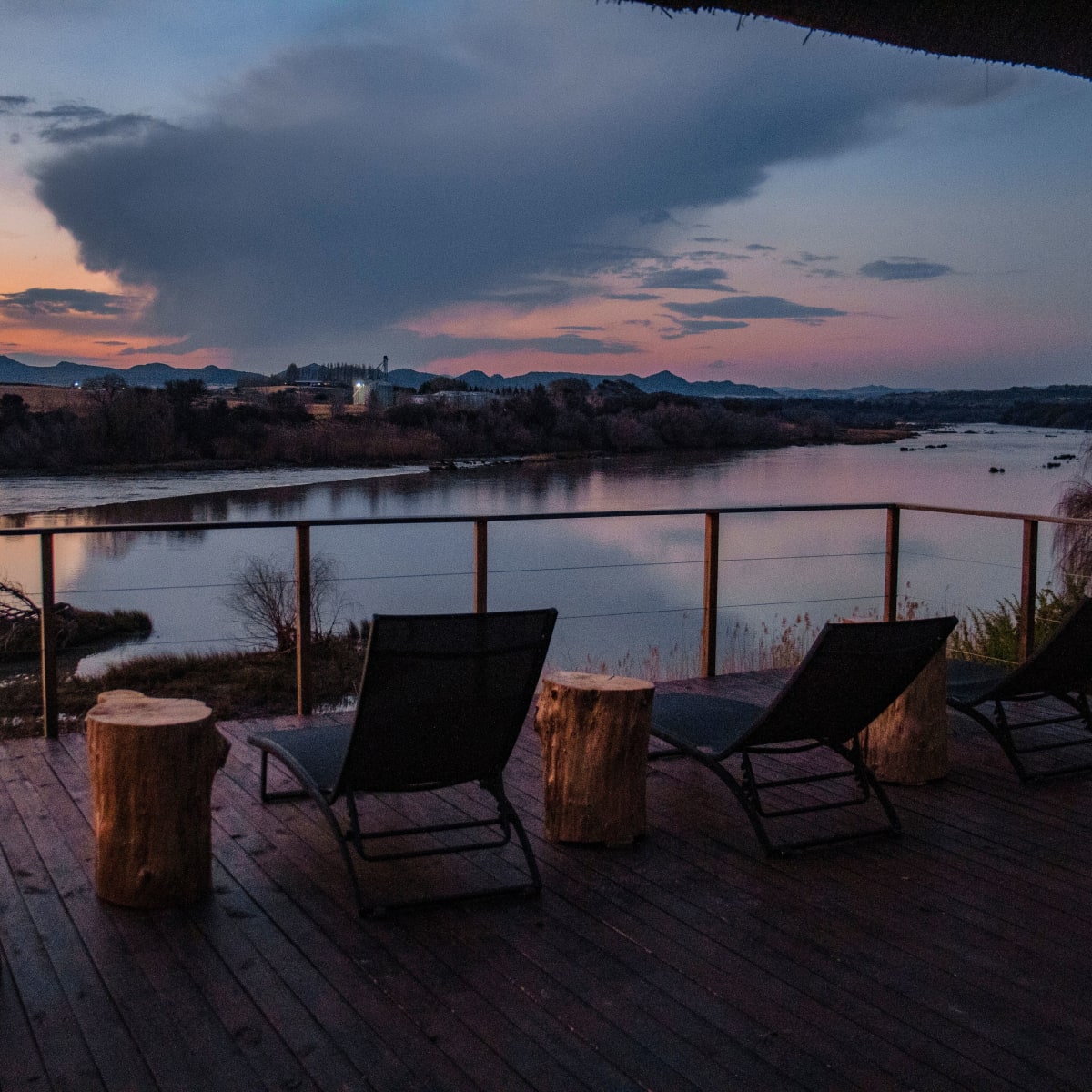 A lodge deck over the river at sunset