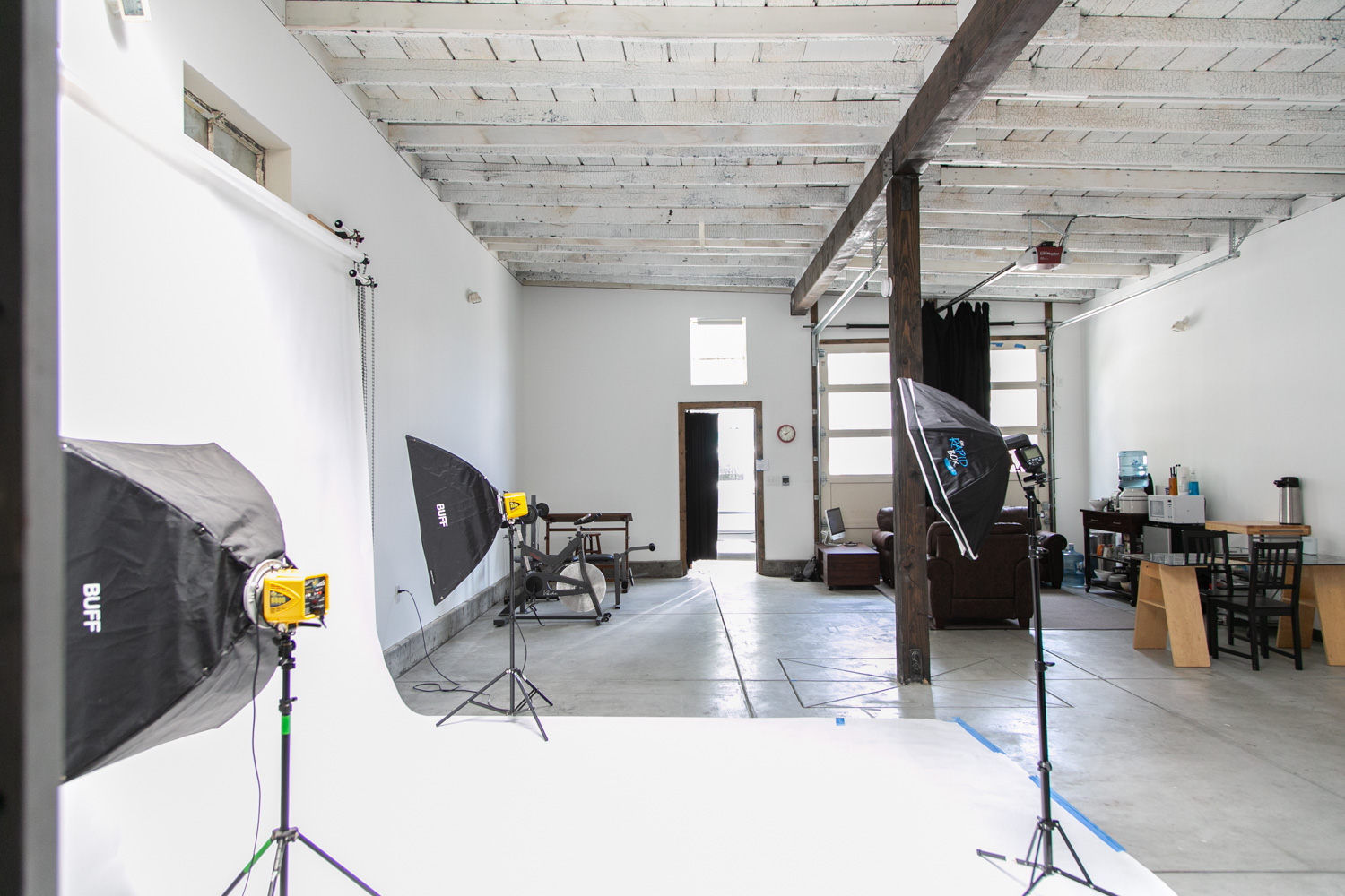 A model poses dramatically in a black outfit during a photo shoot in a studio in San Francisco.