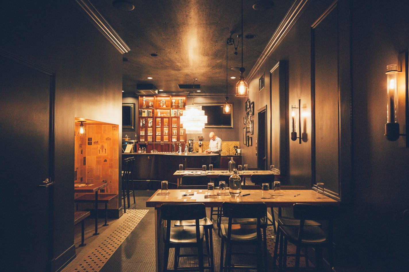 A group of people is networking and engaging in conversation during a retreat in a stylish indoor venue.