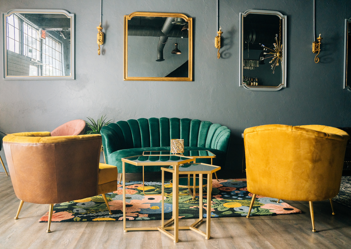 A group of friends gathers in a stylish lounge to celebrate a birthday party.
