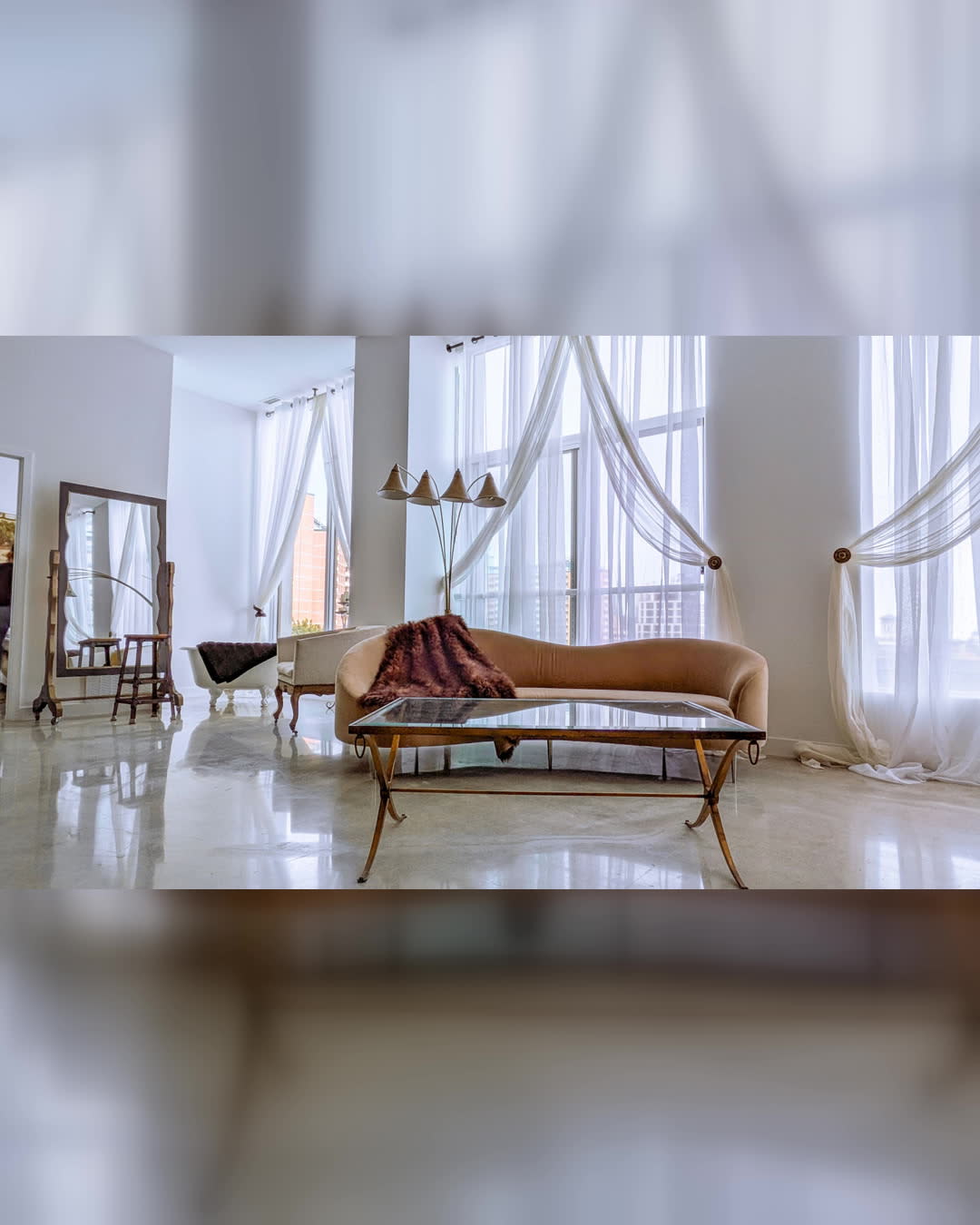 A family poses together for a photo shoot, showcasing formal attire in a stylish indoor setting.