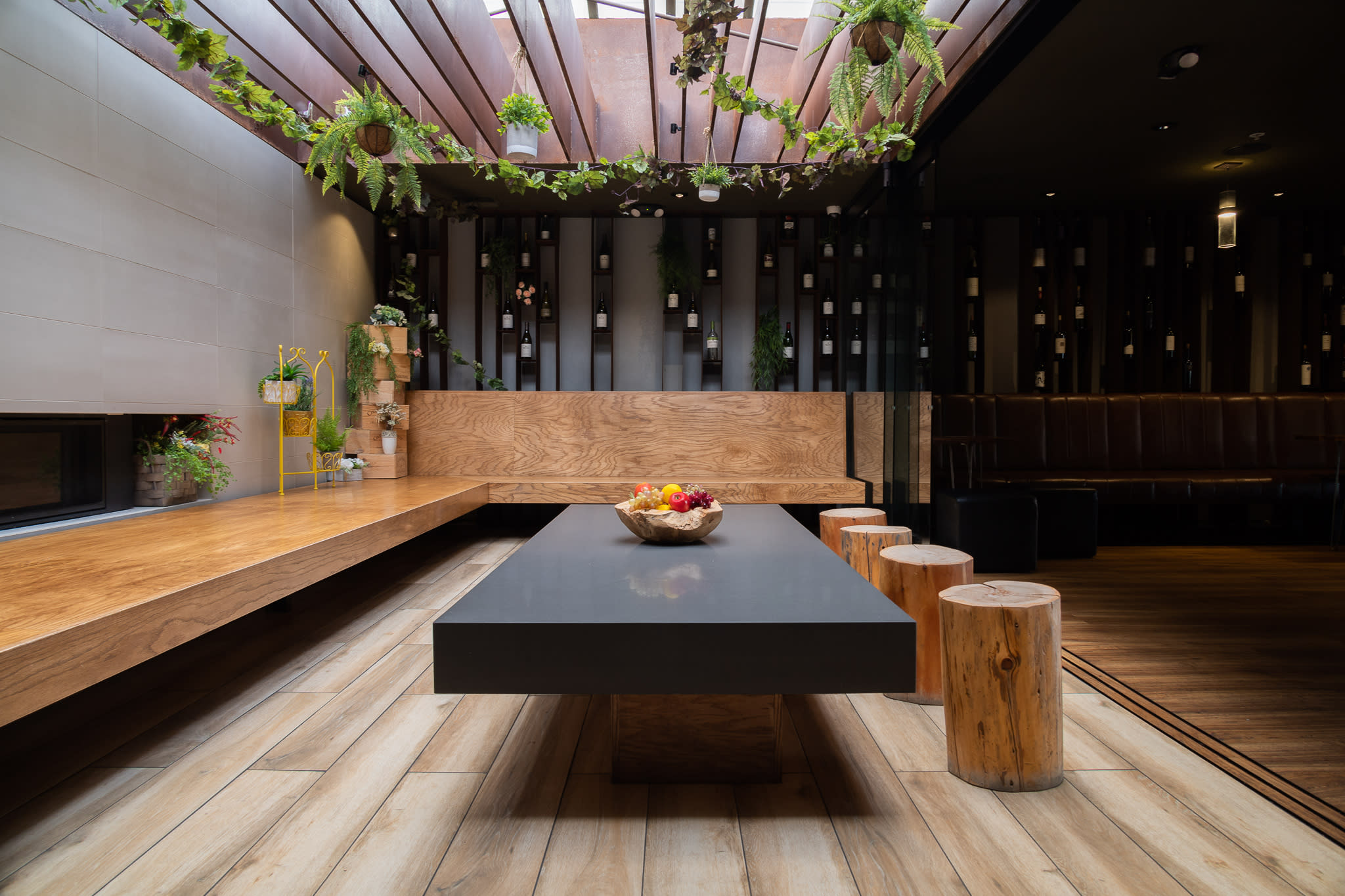 A dimly lit bar area features a long wooden counter with seating, preparing for a birthday celebration.