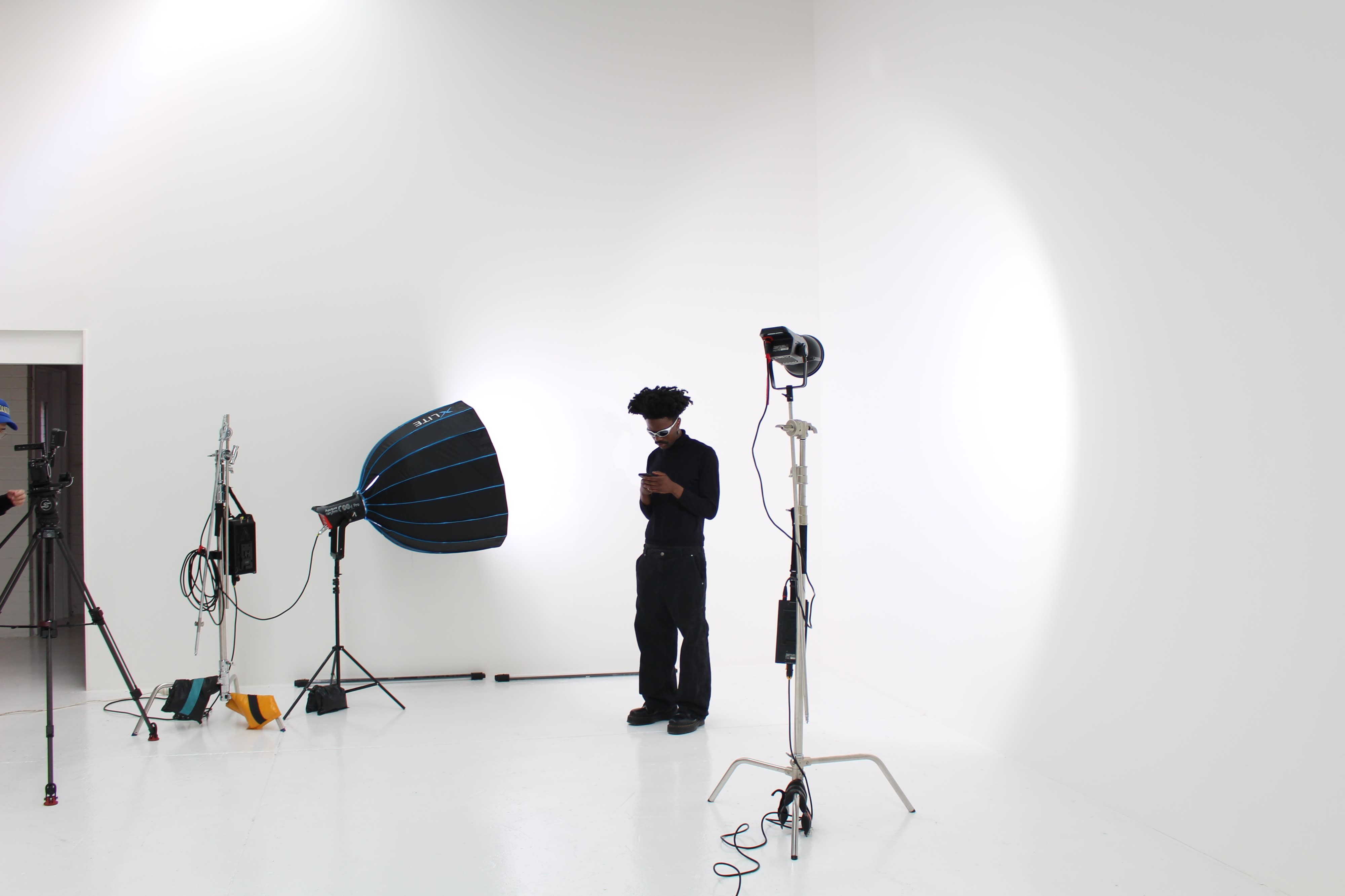 The image features a model posing for a photo shoot, with a focus on her face partially obscured by hair.