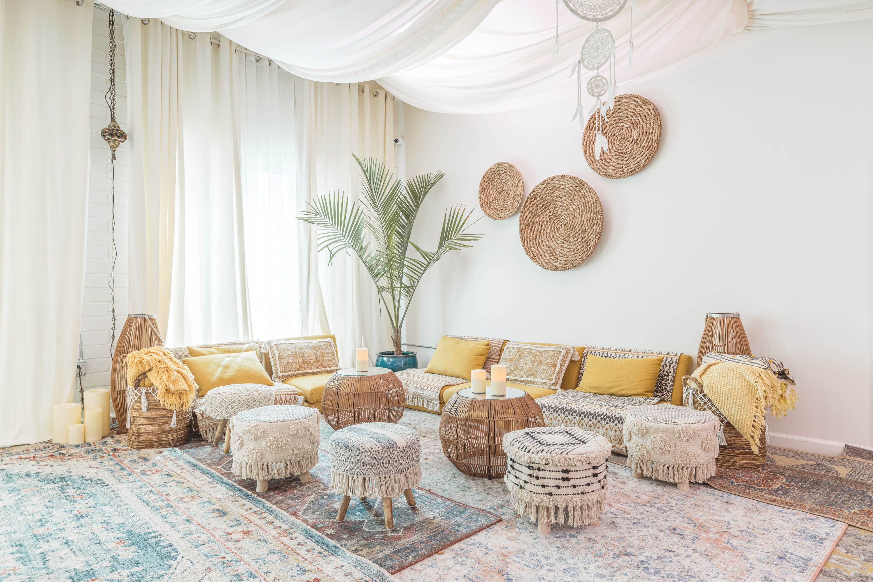 A group of individuals lies on mats in a softly lit space, participating in a relaxation or meditation session.