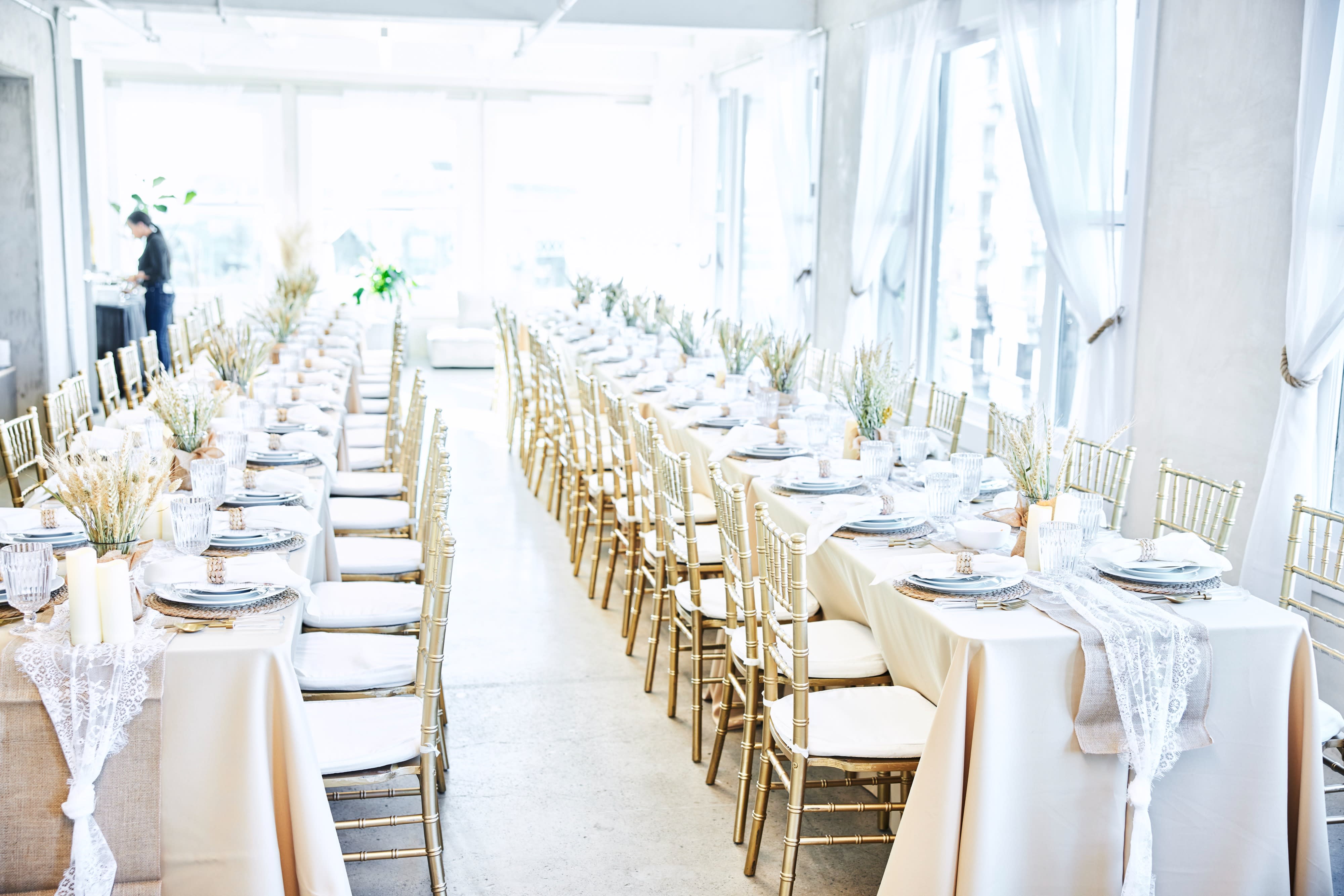 Guests gather around a long table filled with an assortment of donuts and food items at a baby shower.