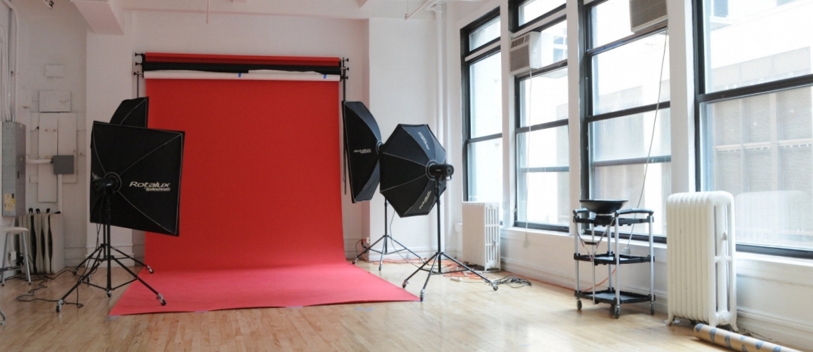 A model poses in profile against a neutral background during a photoshoot.
