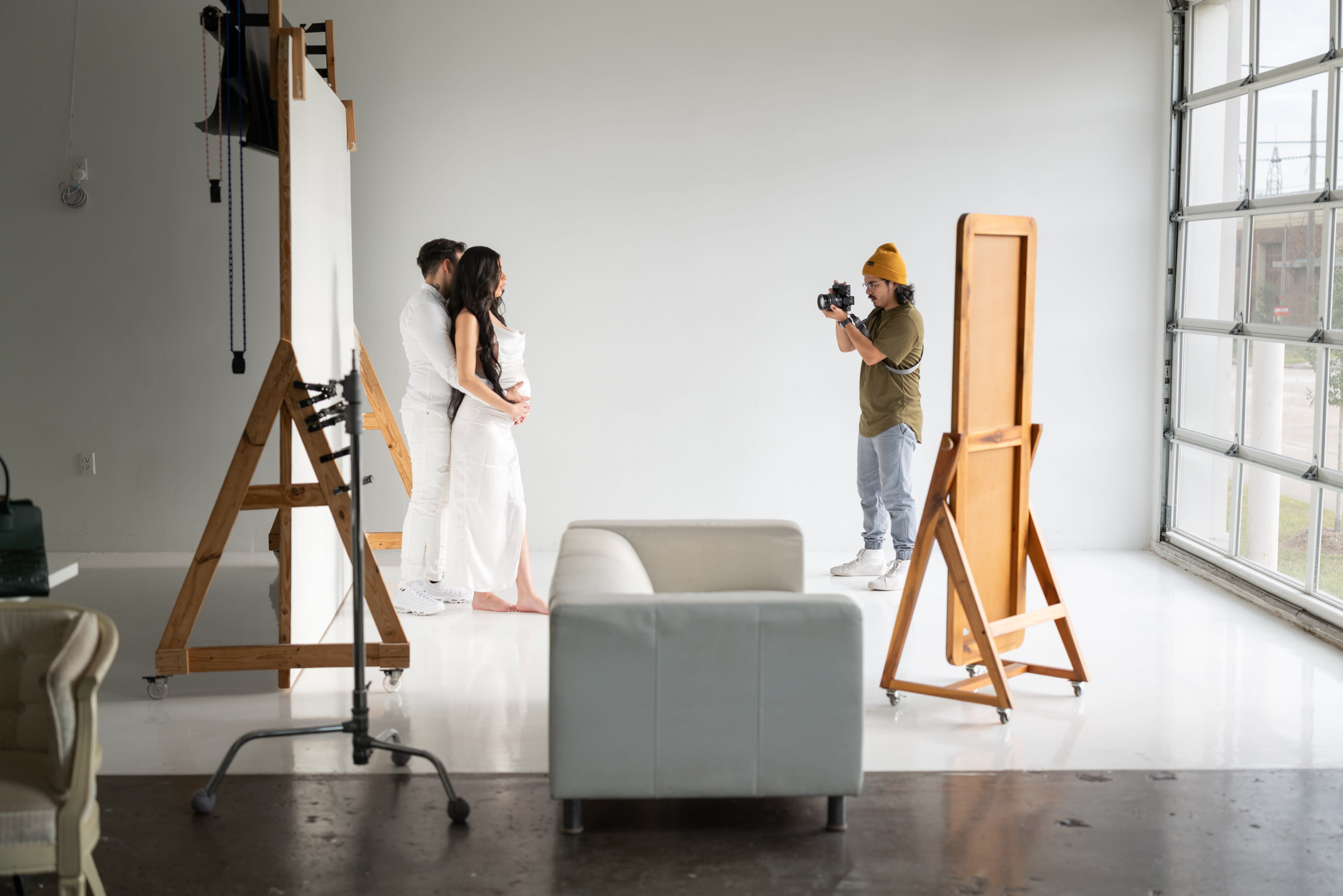 A model poses confidently in a studio setting, showcasing a stylish outfit with a high slit and a cropped top.