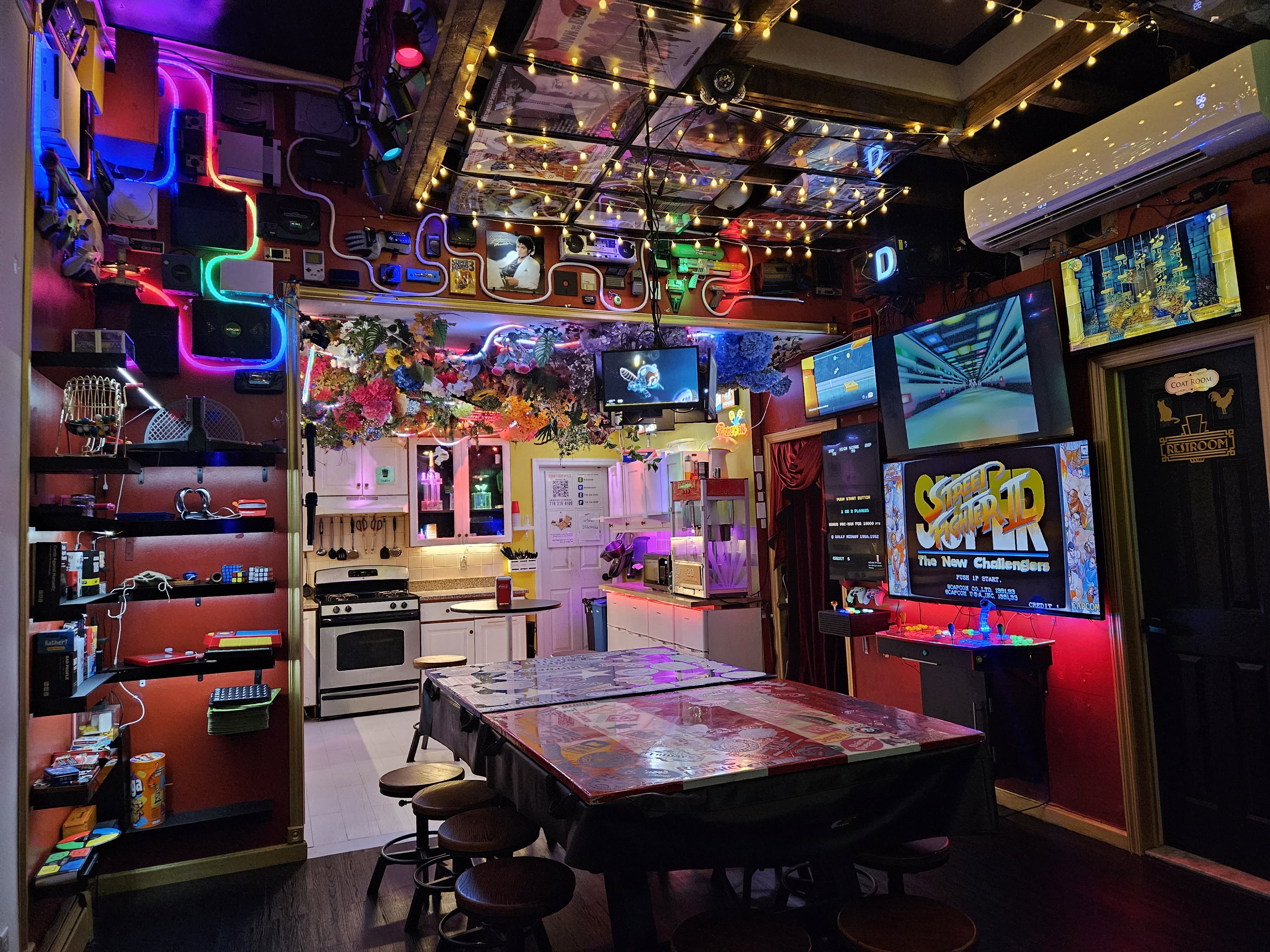A staircase lined with vibrant movie posters leads to an upstairs birthday party venue.