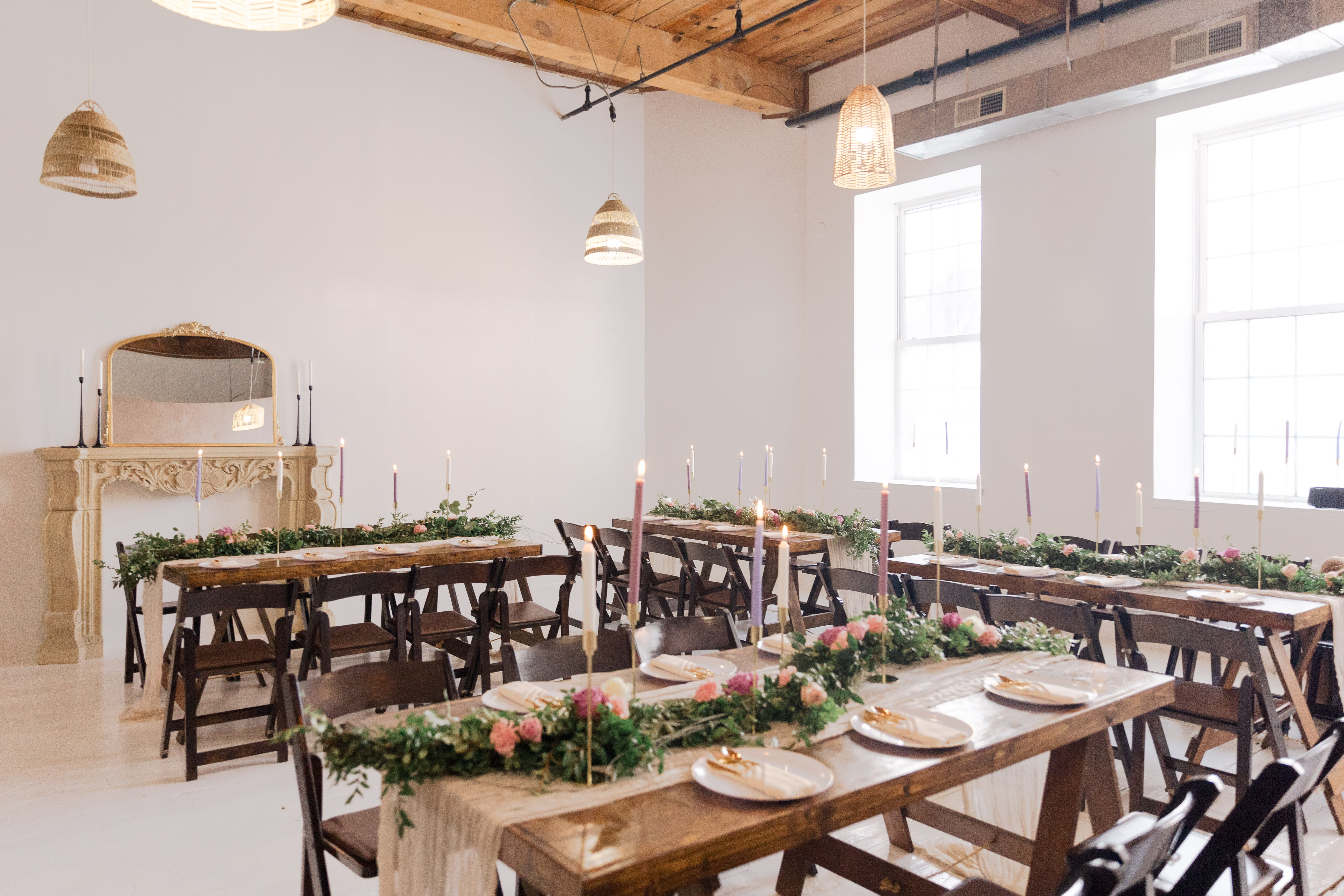 A couple stands at an altar, exchanging vows during their wedding ceremony, while guests sit in rows on either side.