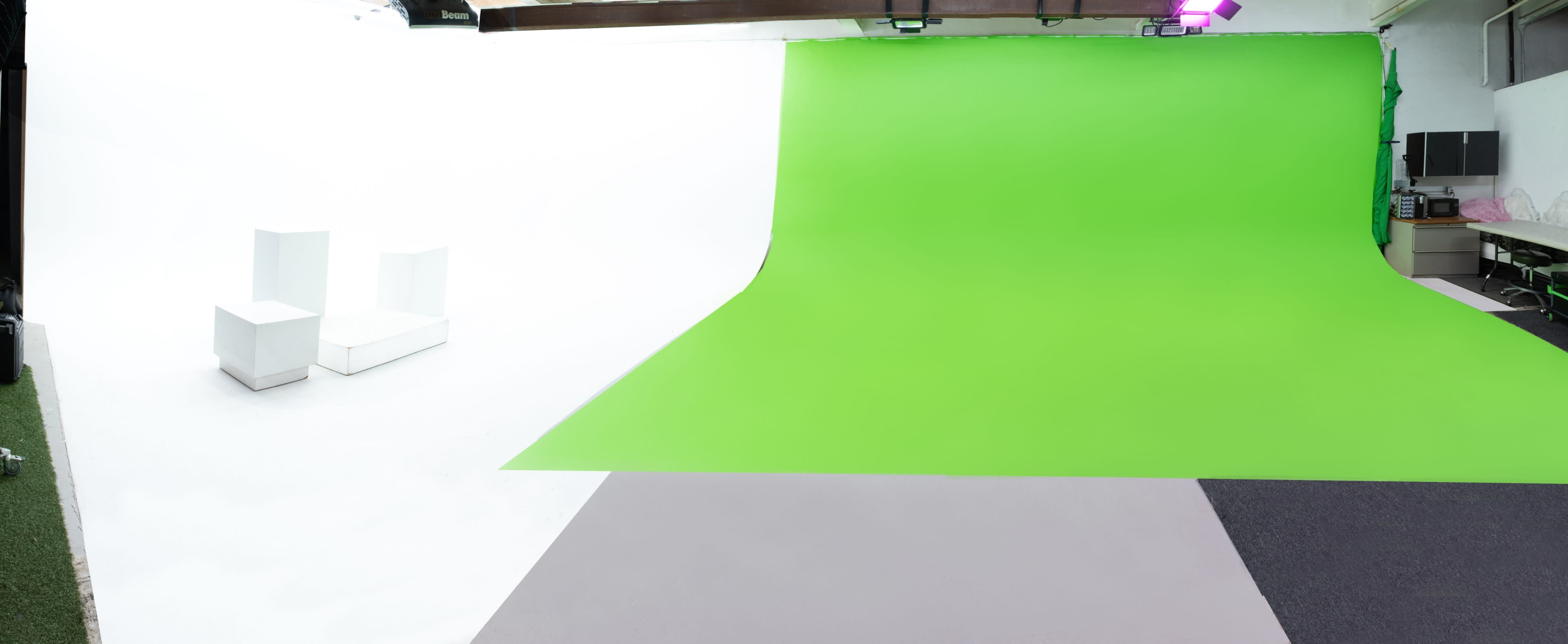 A film crew operates on a green screen set, preparing to shoot a scene with a performer dressed in a sequined outfit.