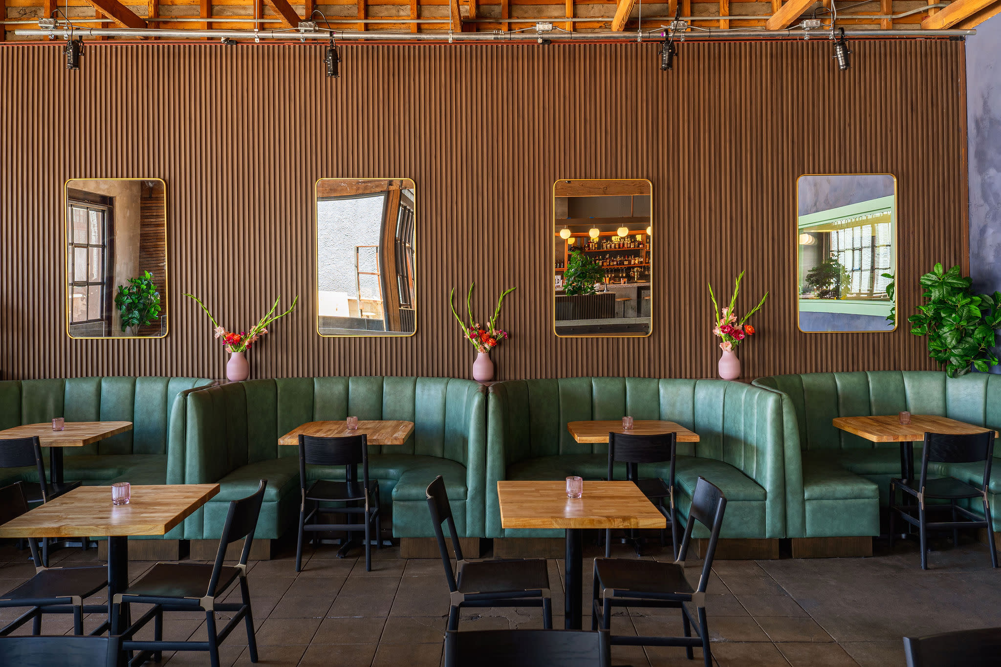 A well-decorated bar area features a variety of snacks and drinks, with plants and records adding to the ambiance.