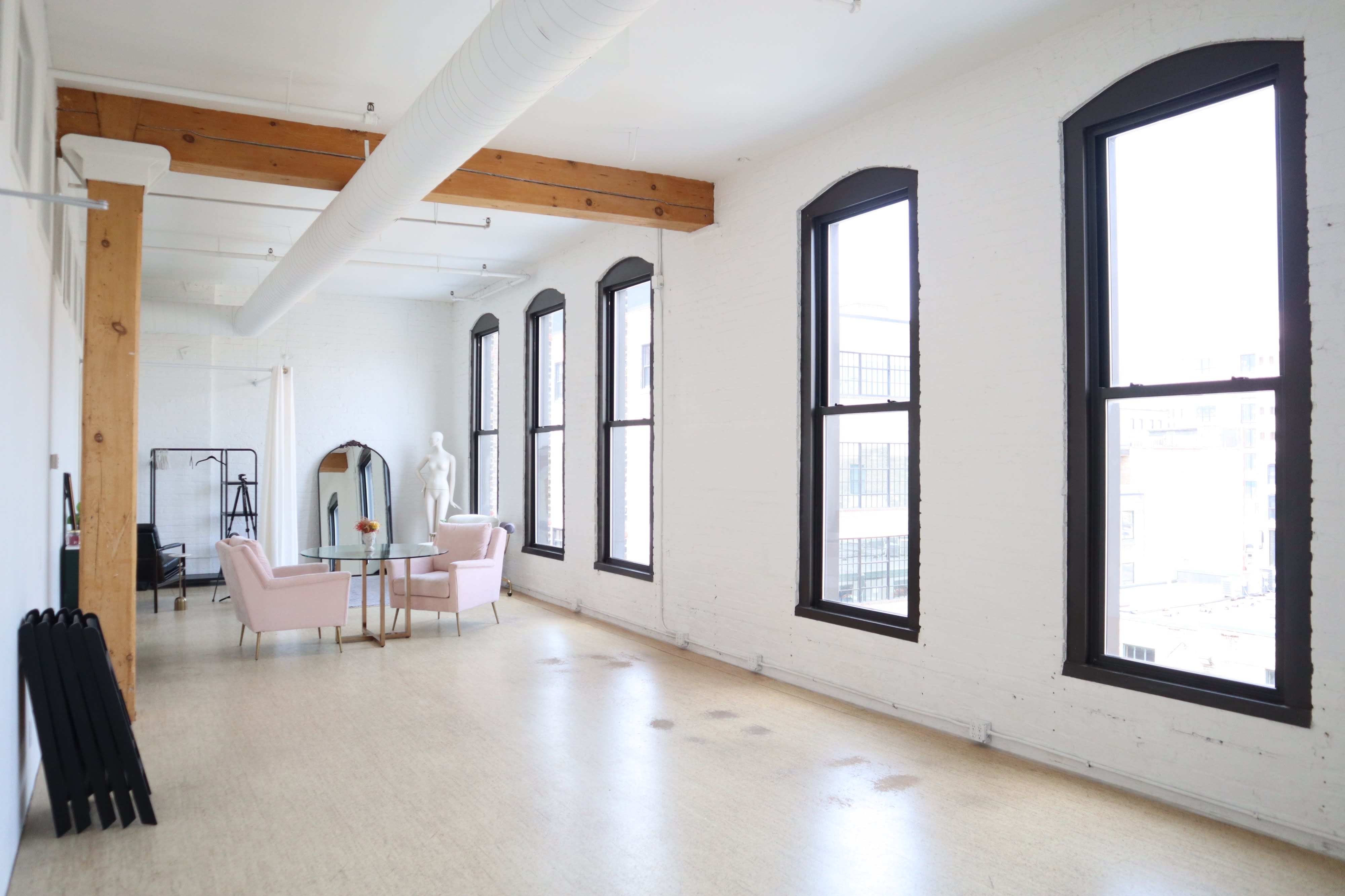 A Halloween-themed photoshoot setup features a mirror, pink fringe decorations, and a "Boo" banner.