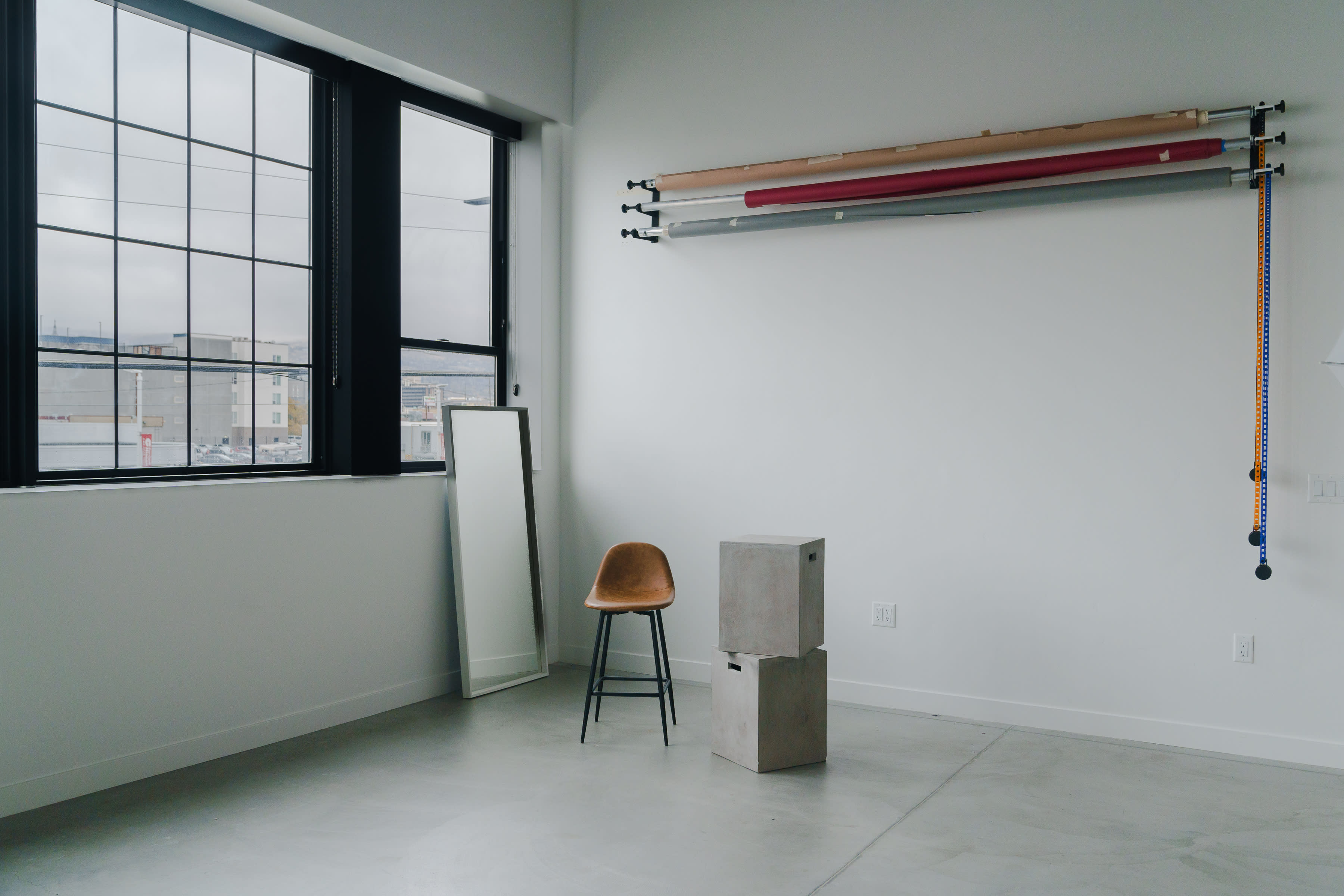A musician plays the violin in a spacious room during a video shoot.