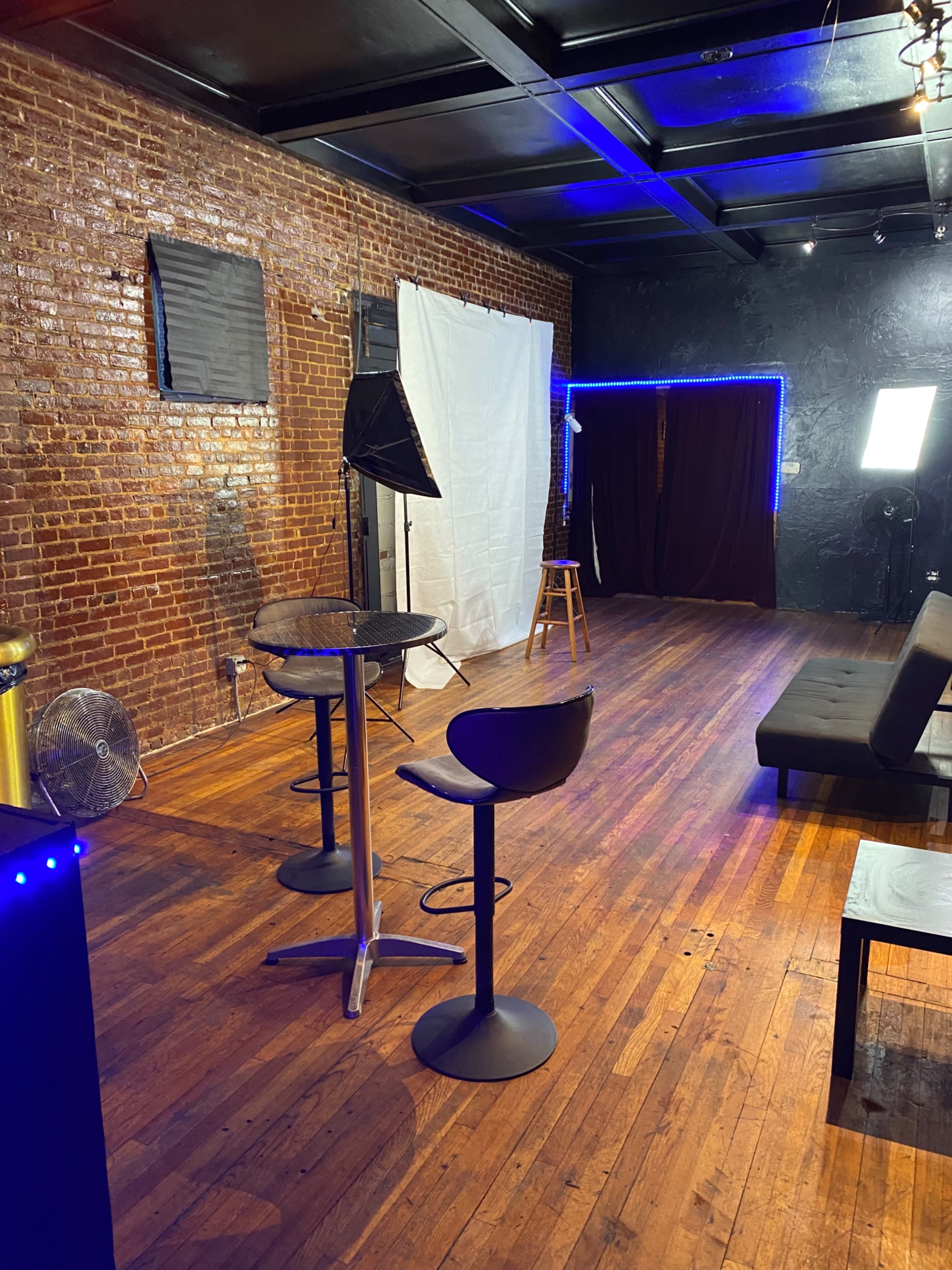 A band poses for a photo shoot in a smoky studio setting.