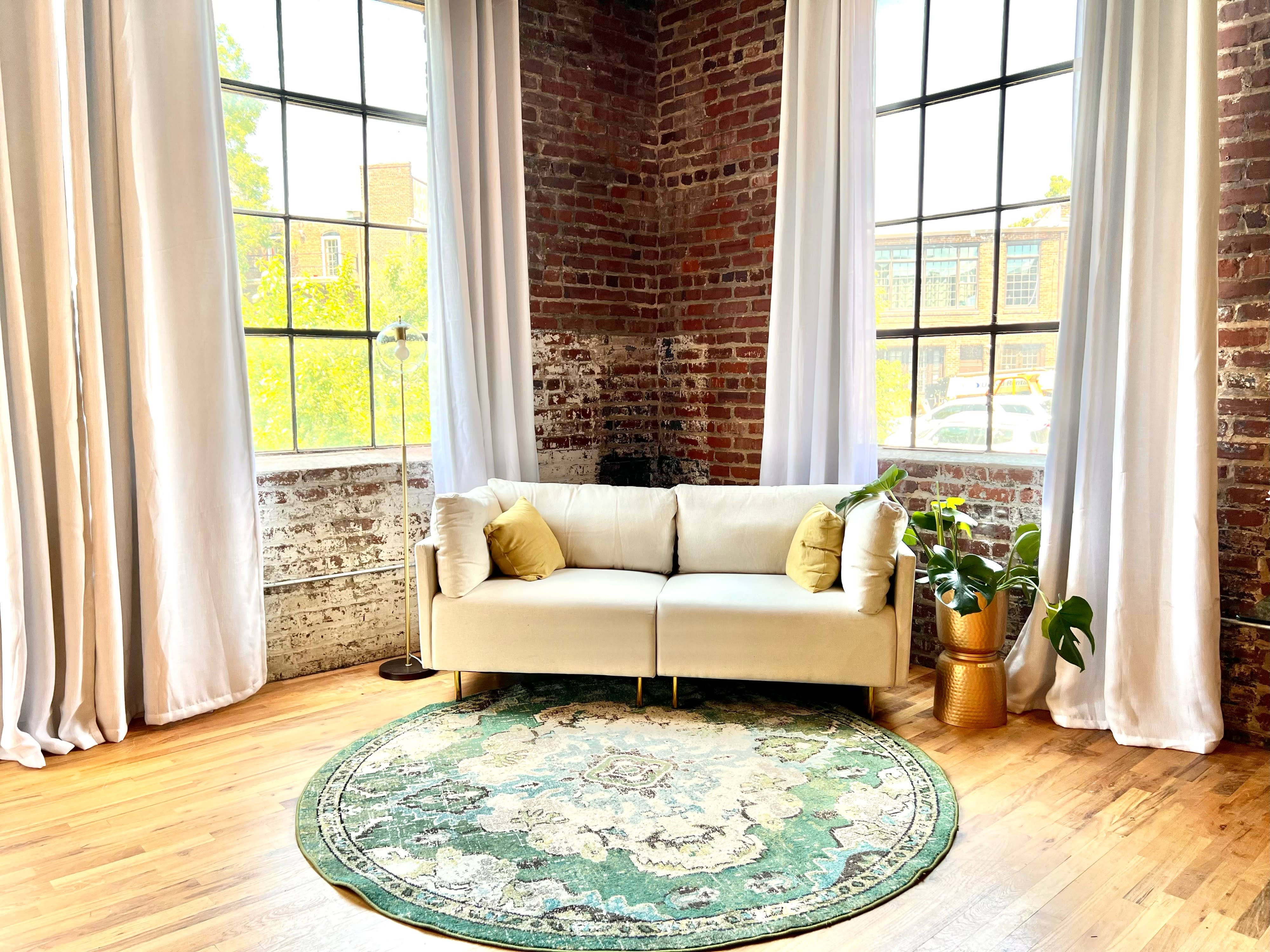 The room is decorated with two Christmas trees, a cozy chair, and a fireplace, creating a festive atmosphere for a 60th birthday party.
