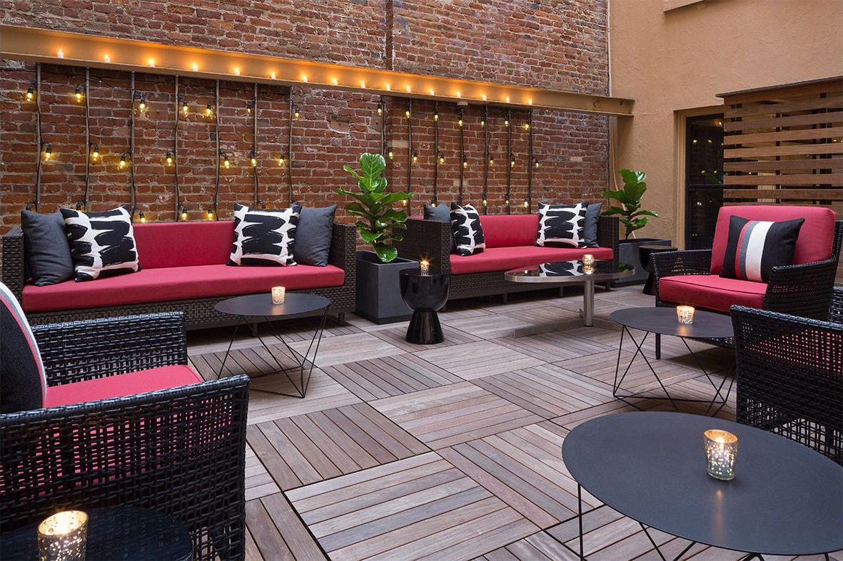 A meeting room is set up with a large rectangular table, chairs, and a display screen, ready for a formal event.