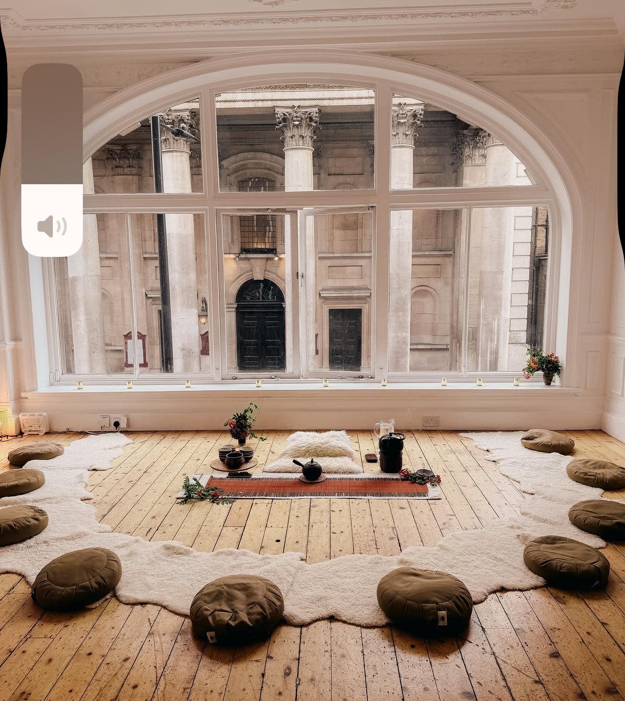 A wellness workshop space features exercise mats arranged on the floor with various colored exercise balls placed throughout the area.