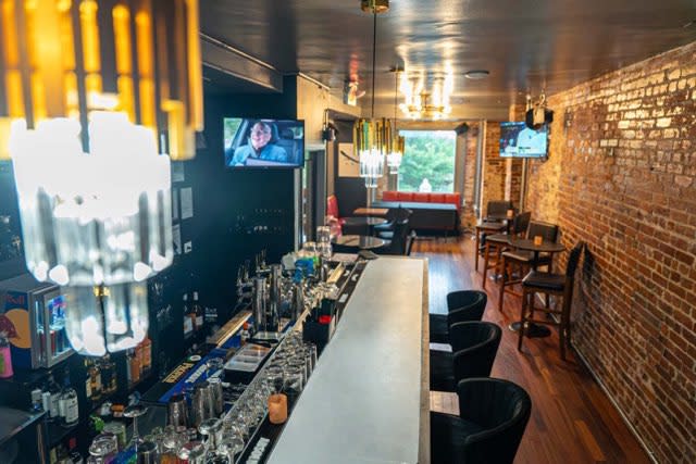 The bar area features decorated walls, twinkling lights, and a festive atmosphere for a birthday party.