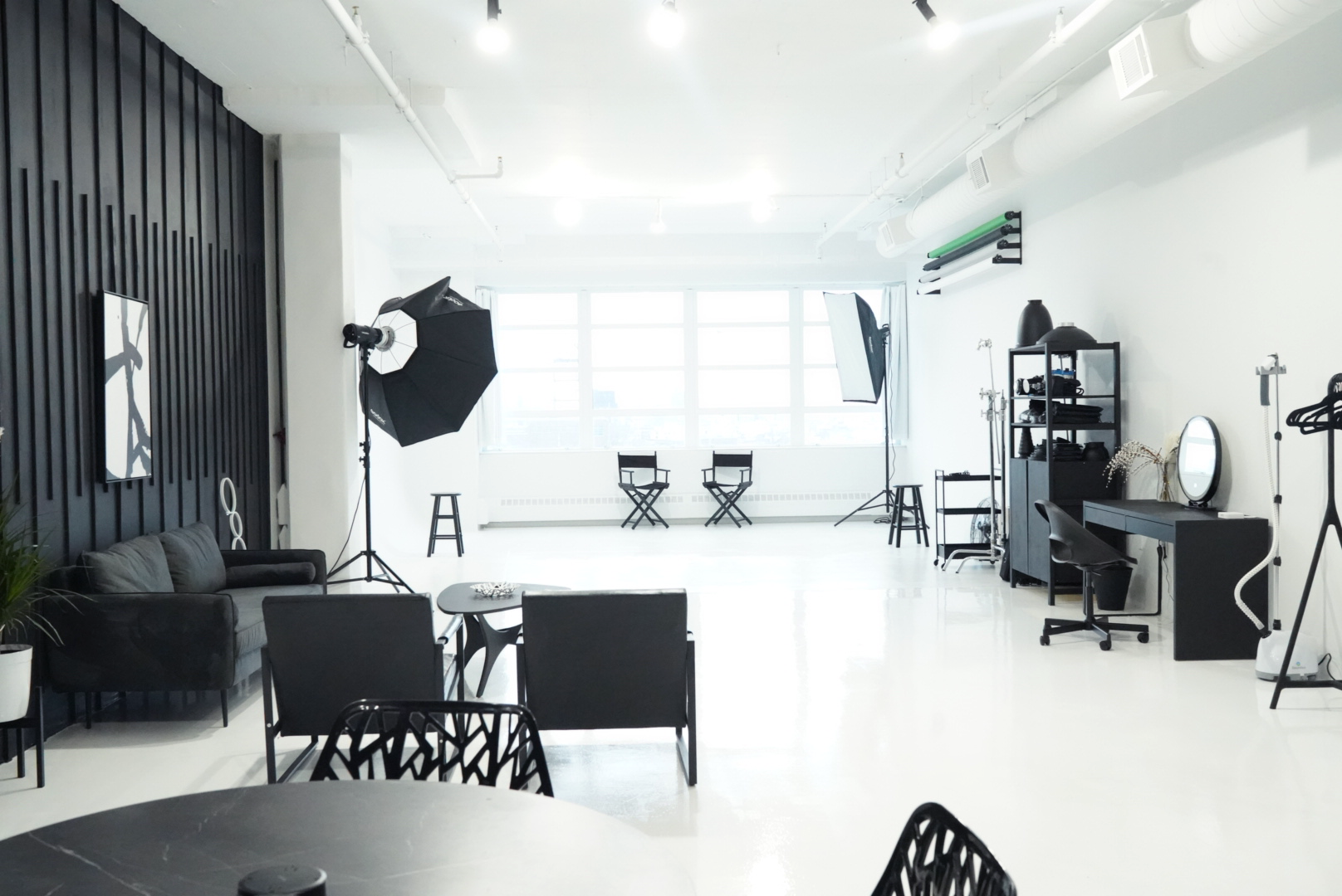 A person sits on a black chair in a podcast studio, surrounded by modern decor and a large screen displaying the title "Winners Culture Podcast."