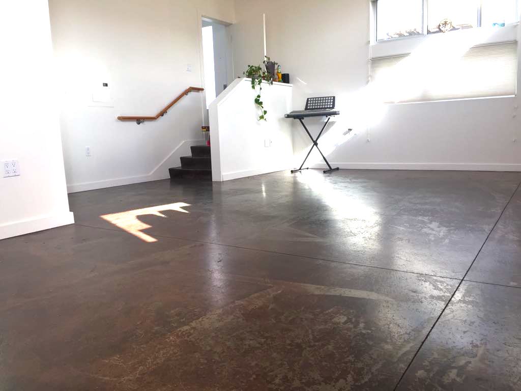 The photo studio features a backdrop, lighting equipment, and a chair set up for a photoshoot.