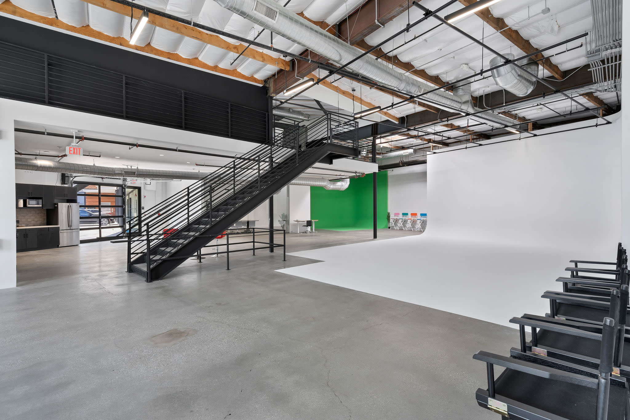 A team sets up a photography studio with lights and cameras for a production shoot.