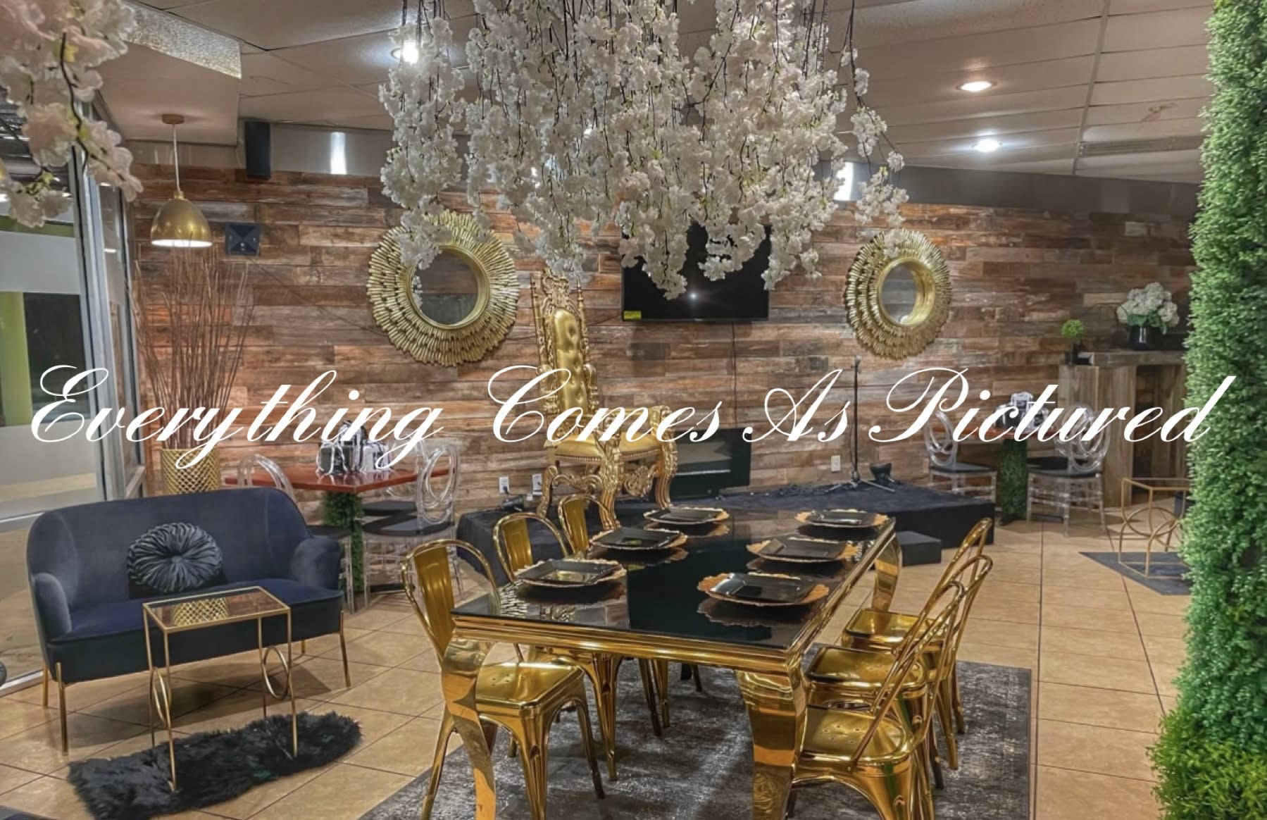 A lavish birthday party setup features gold chairs and a glossy table adorned with greenery in a stylish venue.