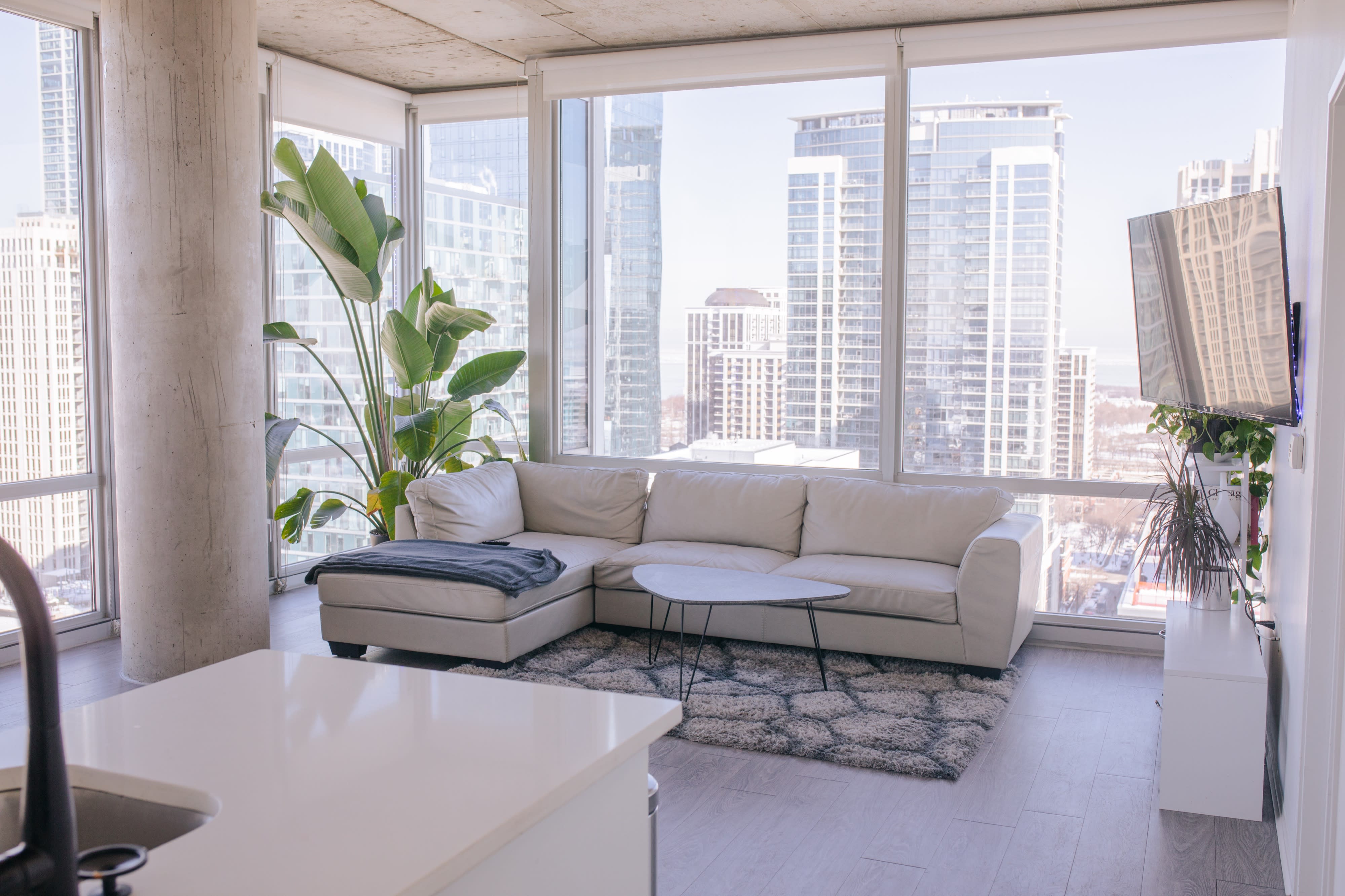 A video shoot captures a panoramic view of the Chicago skyline from a high-rise apartment.