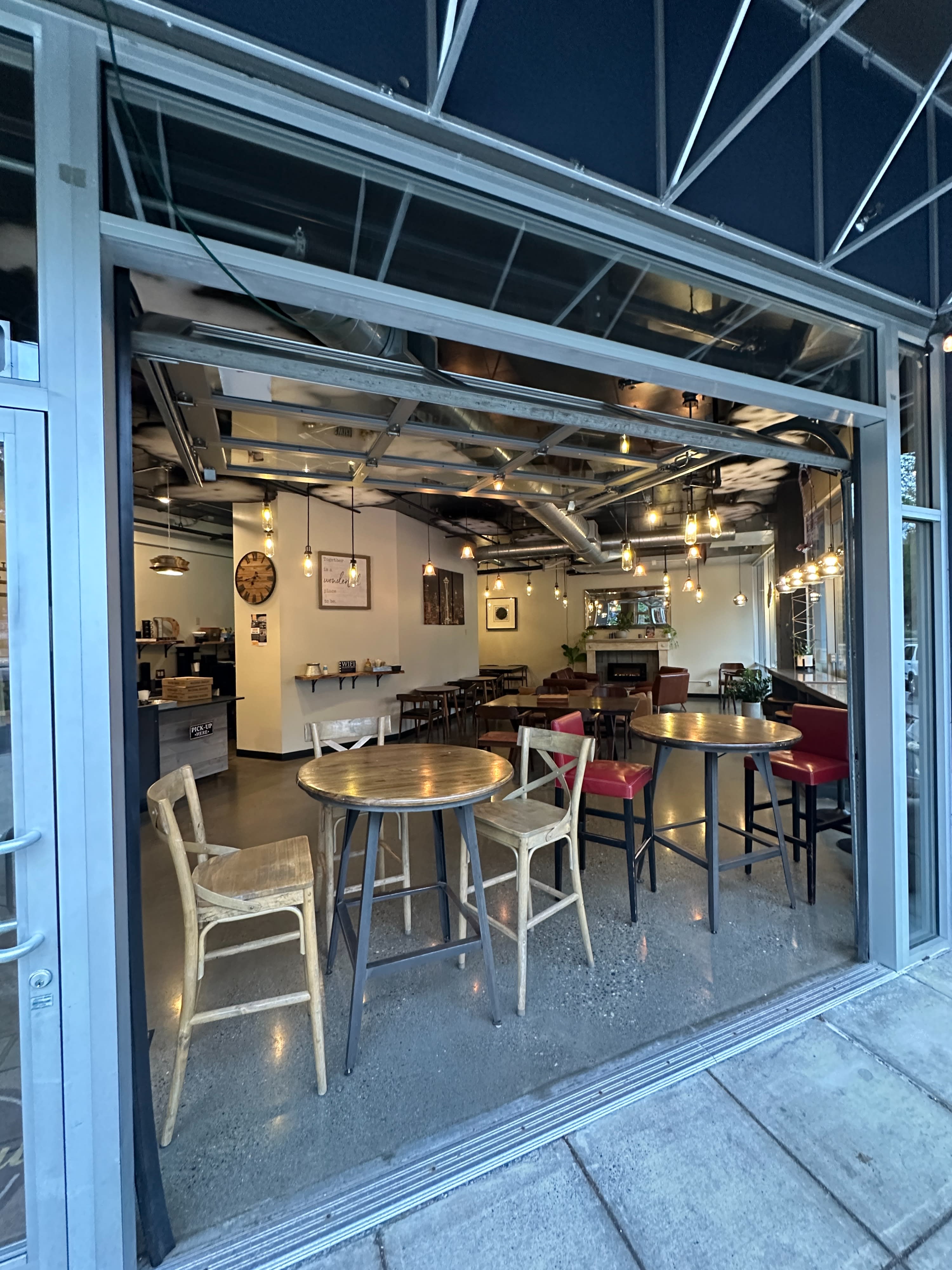 People sit quietly in a café, engaging in conversation and relaxation while others are seen at the counter.