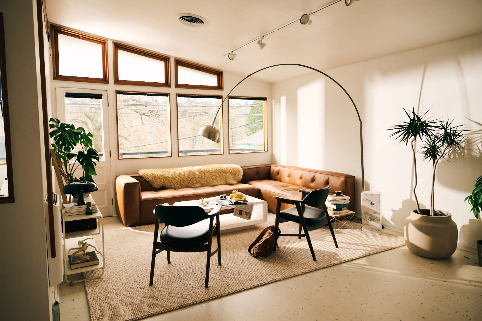 The room is set up for a baby shower, featuring tables adorned with decorations and a spread of assorted finger foods and snacks.