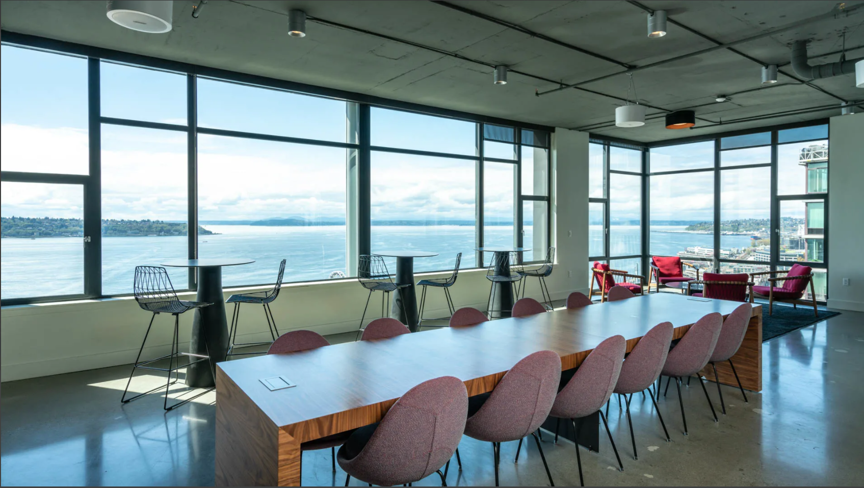 The scene features a decorated corner of a modern room with large windows overlooking a harbor, adorned with "LITTLE PUMPKIN" balloon letters and baby-themed decorations.