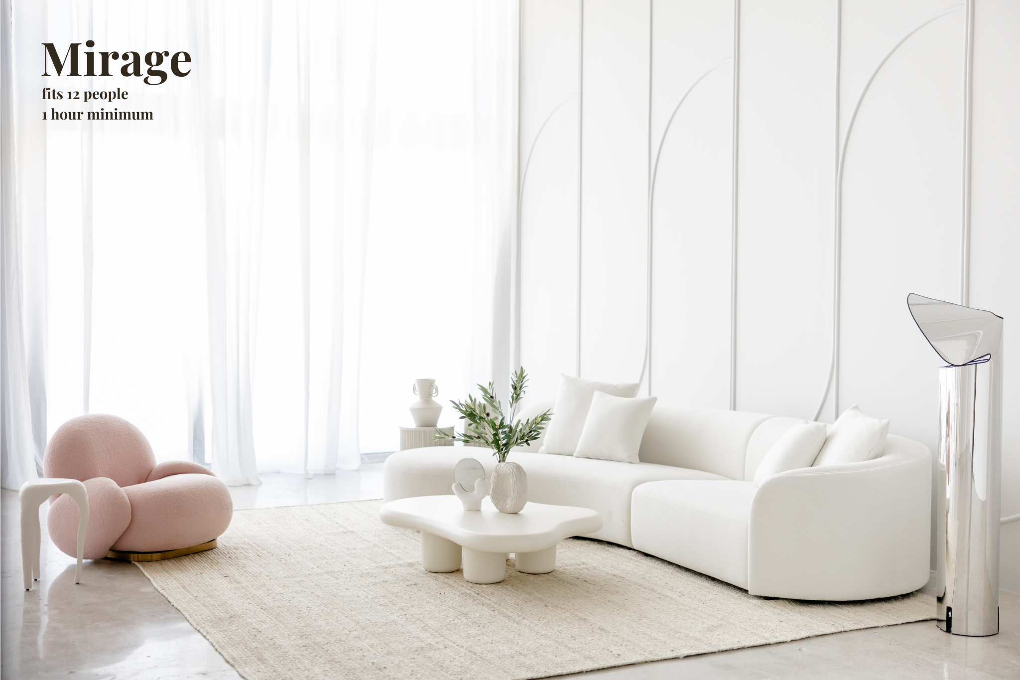 A model poses in a stylish outfit near a decorative plant and a minimalistic architectural feature.