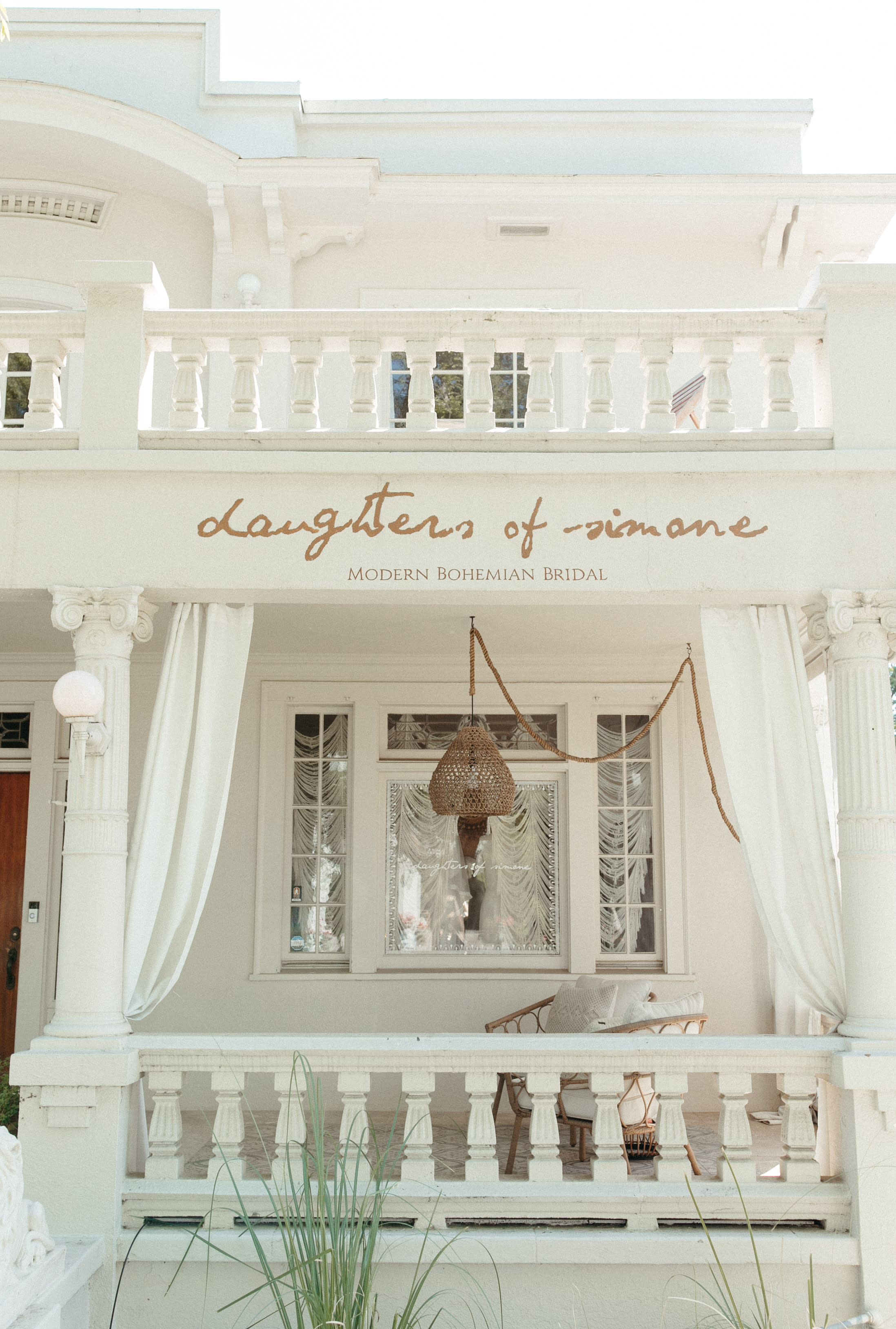 A video shoot takes place in a elegantly decorated room featuring draped fabrics, a dressing table, and a large mirror.