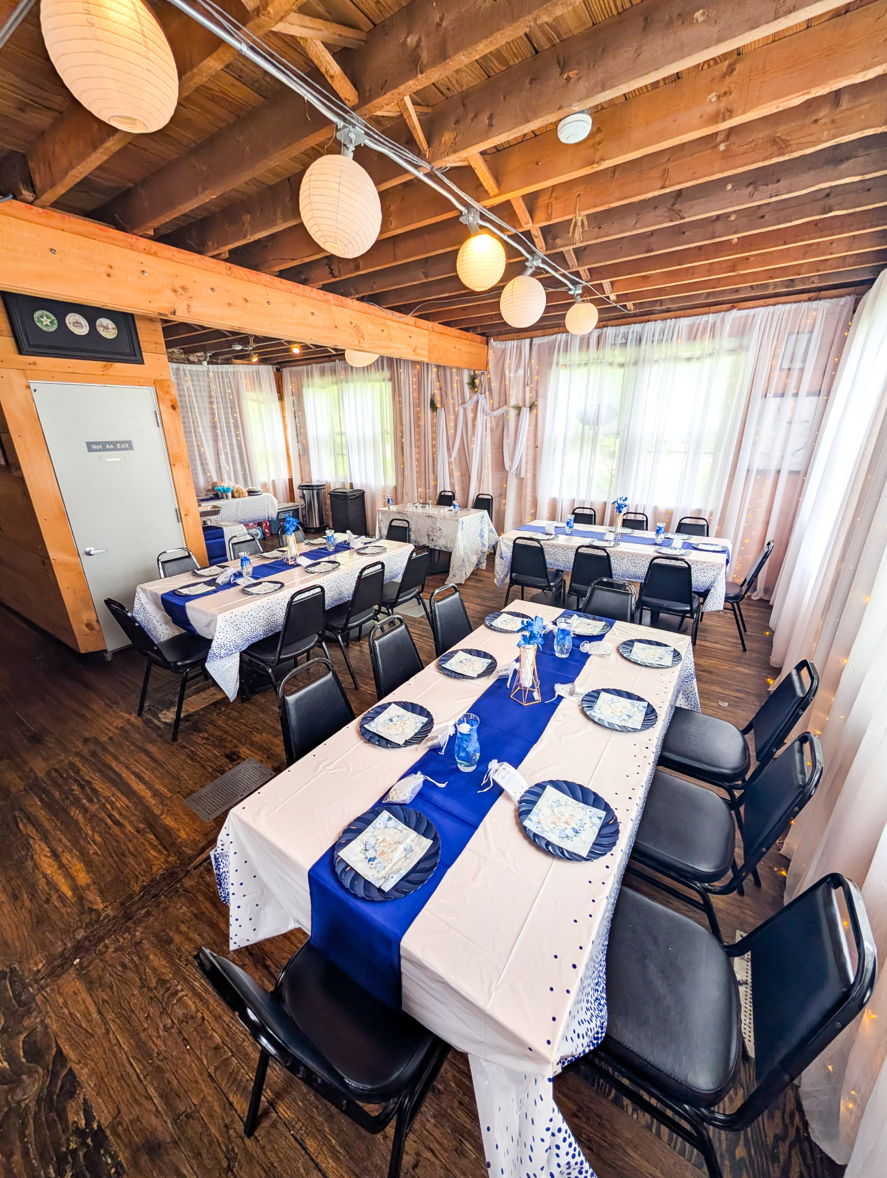The engagement party features a decorated backdrop with a "Happy Engagement" banner and a buffet table set with plates and food under string lights.