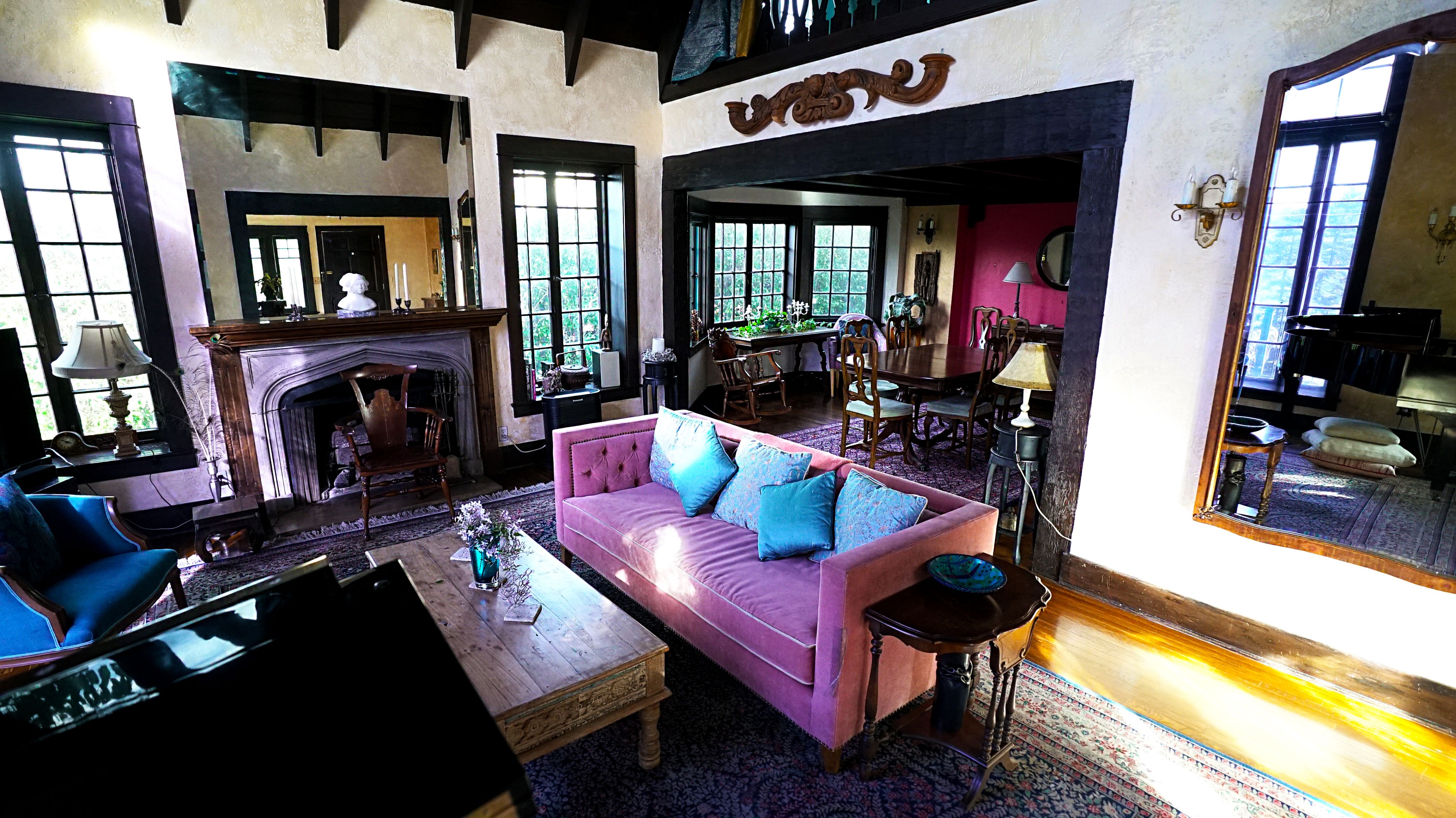 A short film is being shot in a sunlit living room featuring a mix of vintage furniture and decor.