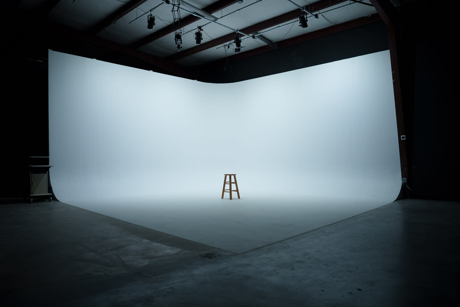 A band strikes a dynamic pose in a studio, showcasing their instruments and directing powerful gestures toward the camera.
