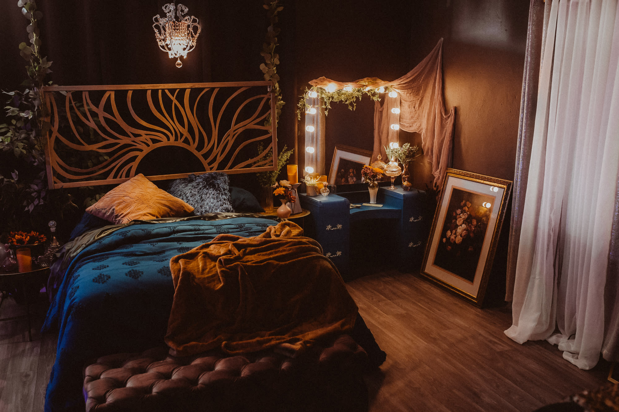 A person lies on a bed draped in a green fabric, surrounded by soft lighting and decorative elements.