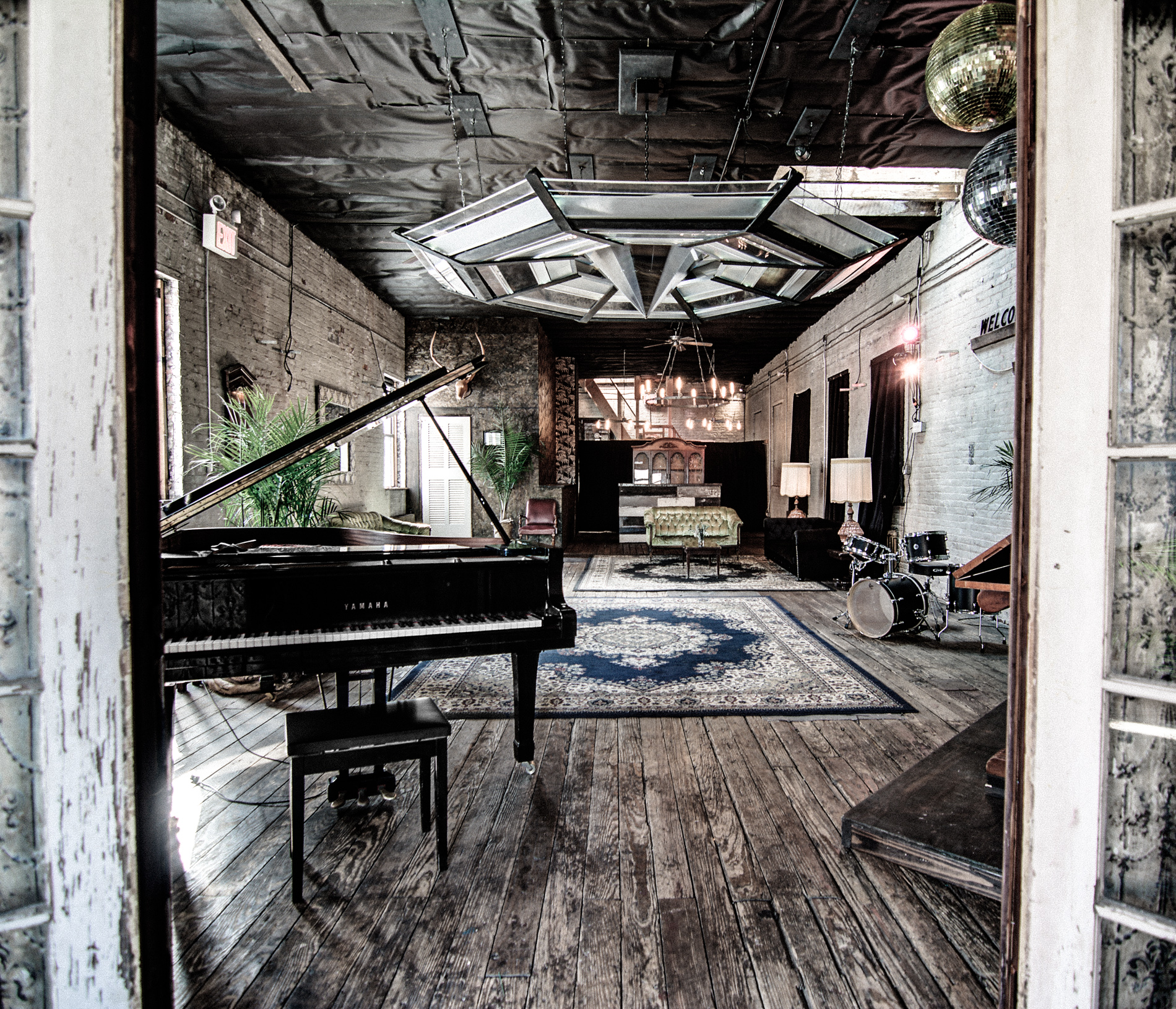 A band performs on stage at a birthday party in an industrial-style venue.