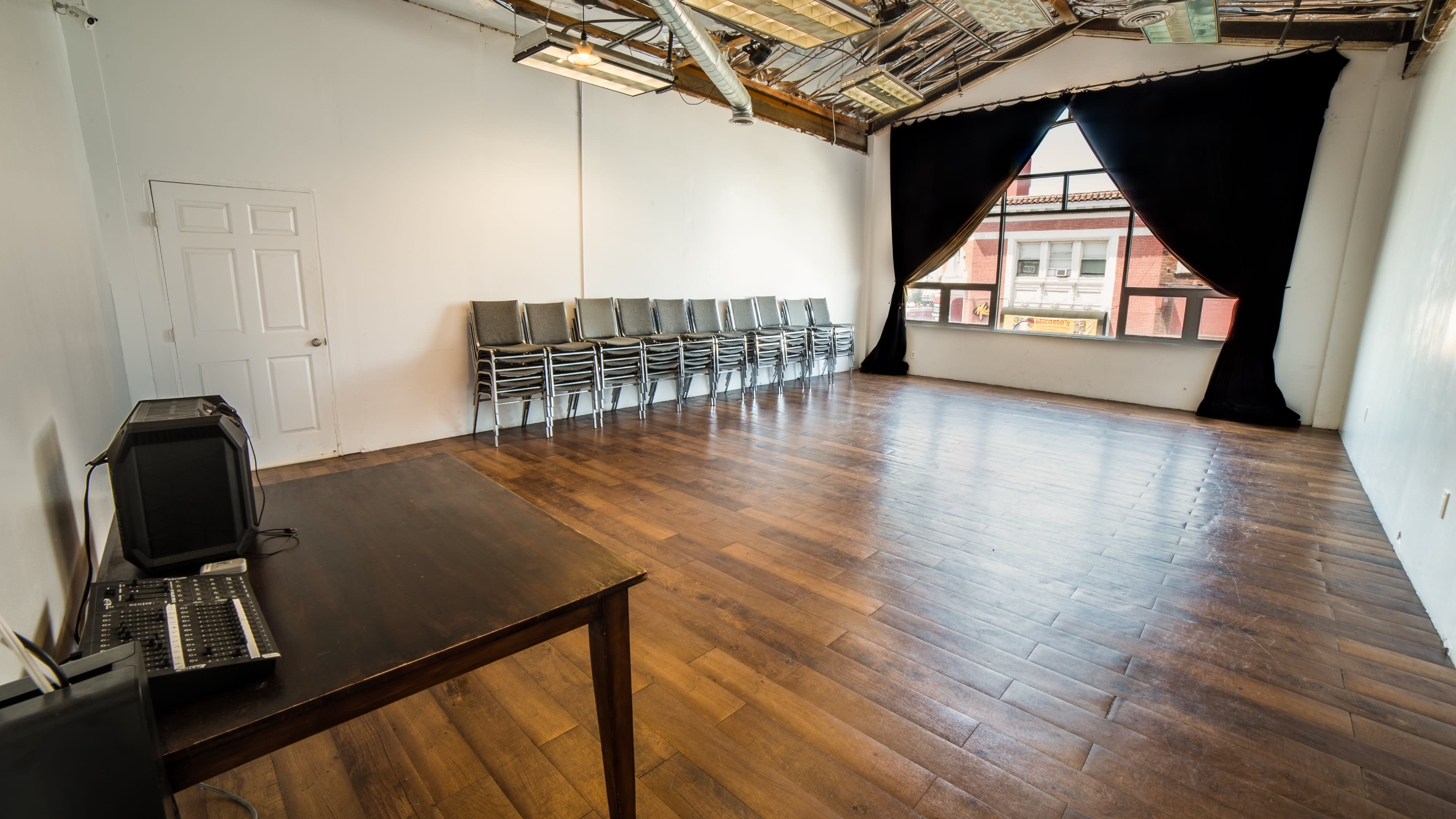 Participants engage in an art workshop, creating drawings on mats in a well-lit studio space.