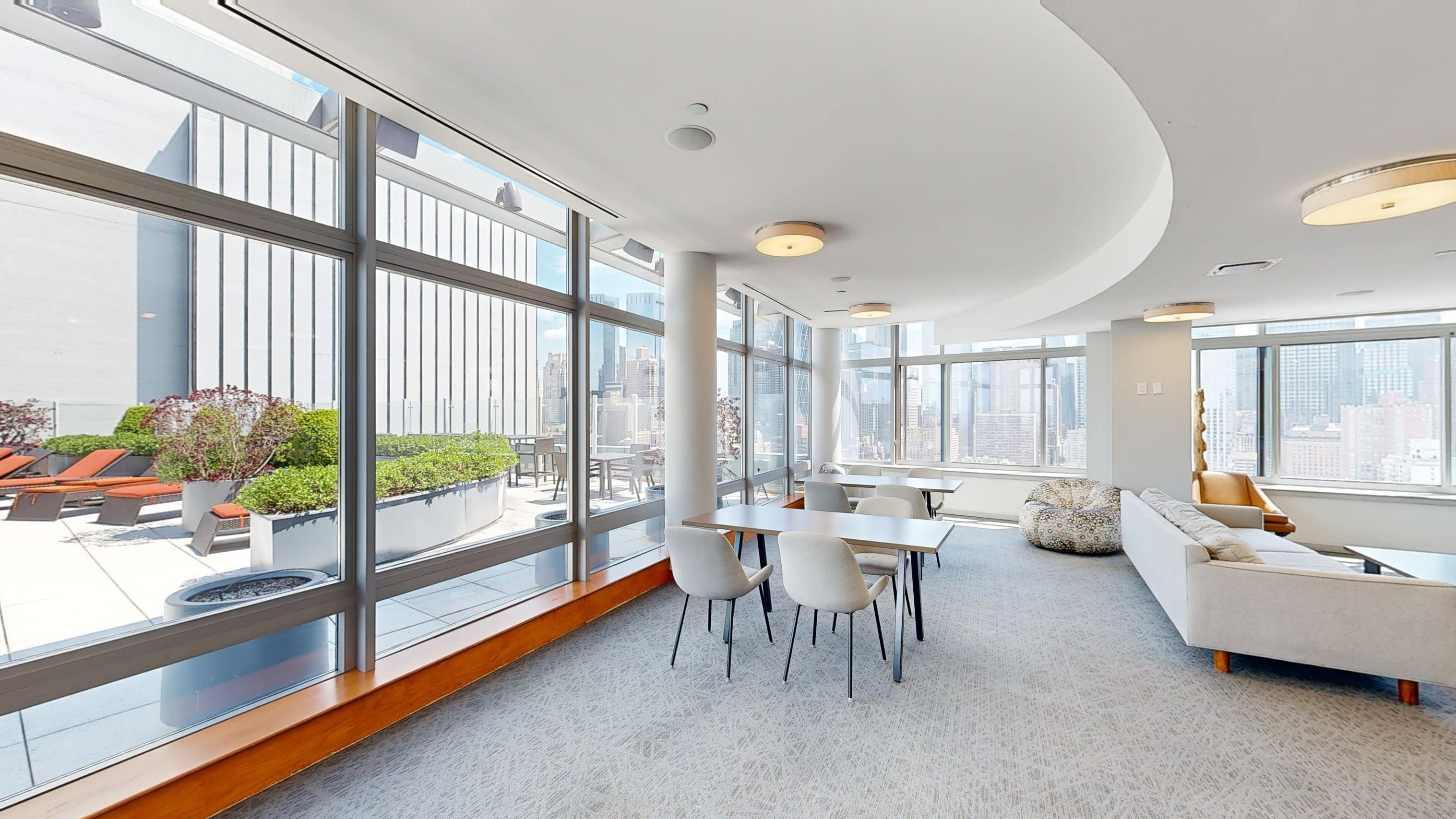 A baby shower is being held with a city skyline view through decorated windows.