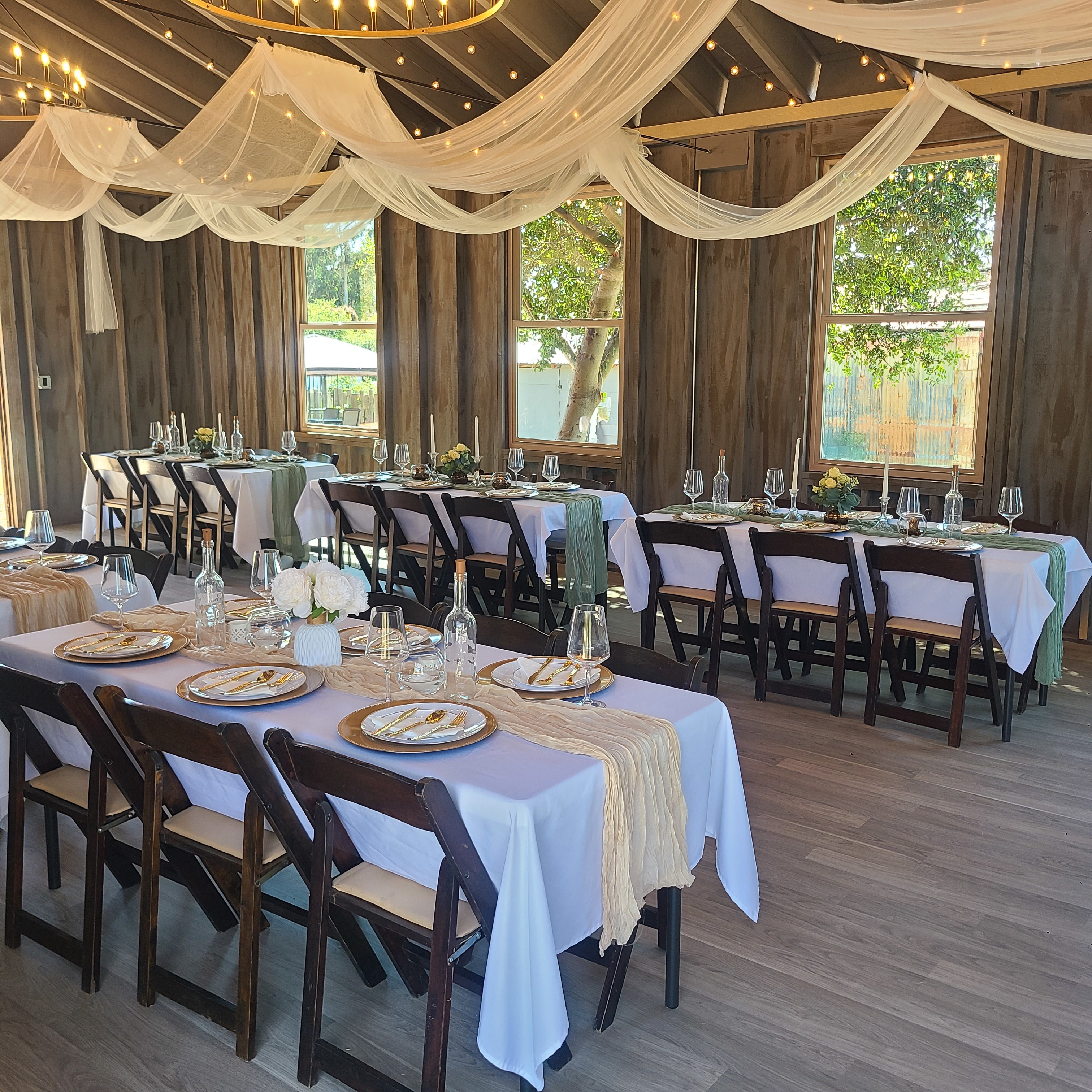 A couple dances joyfully together at their wedding reception, surrounded by floral decorations and soft lighting.