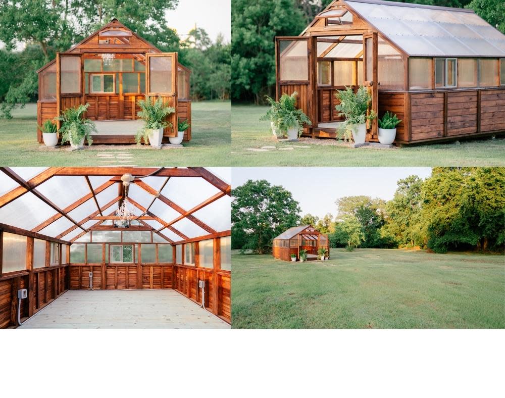 A couple in formal wedding attire shares a kiss inside a greenhouse.