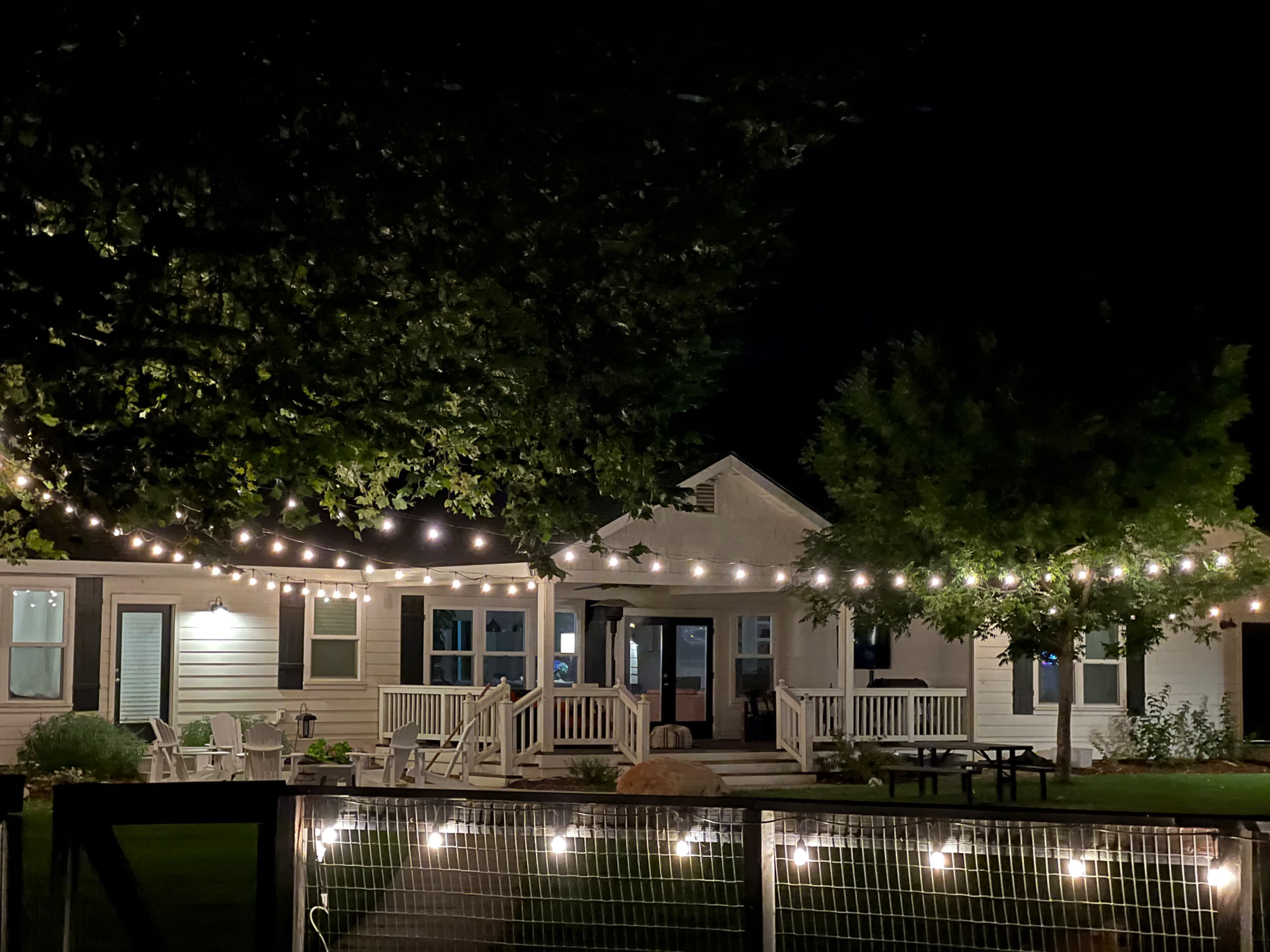 A beautifully decorated outdoor space features a themed baby shower setup with a large "BABY" sign, elegant seating, and an arrangement of balloons.