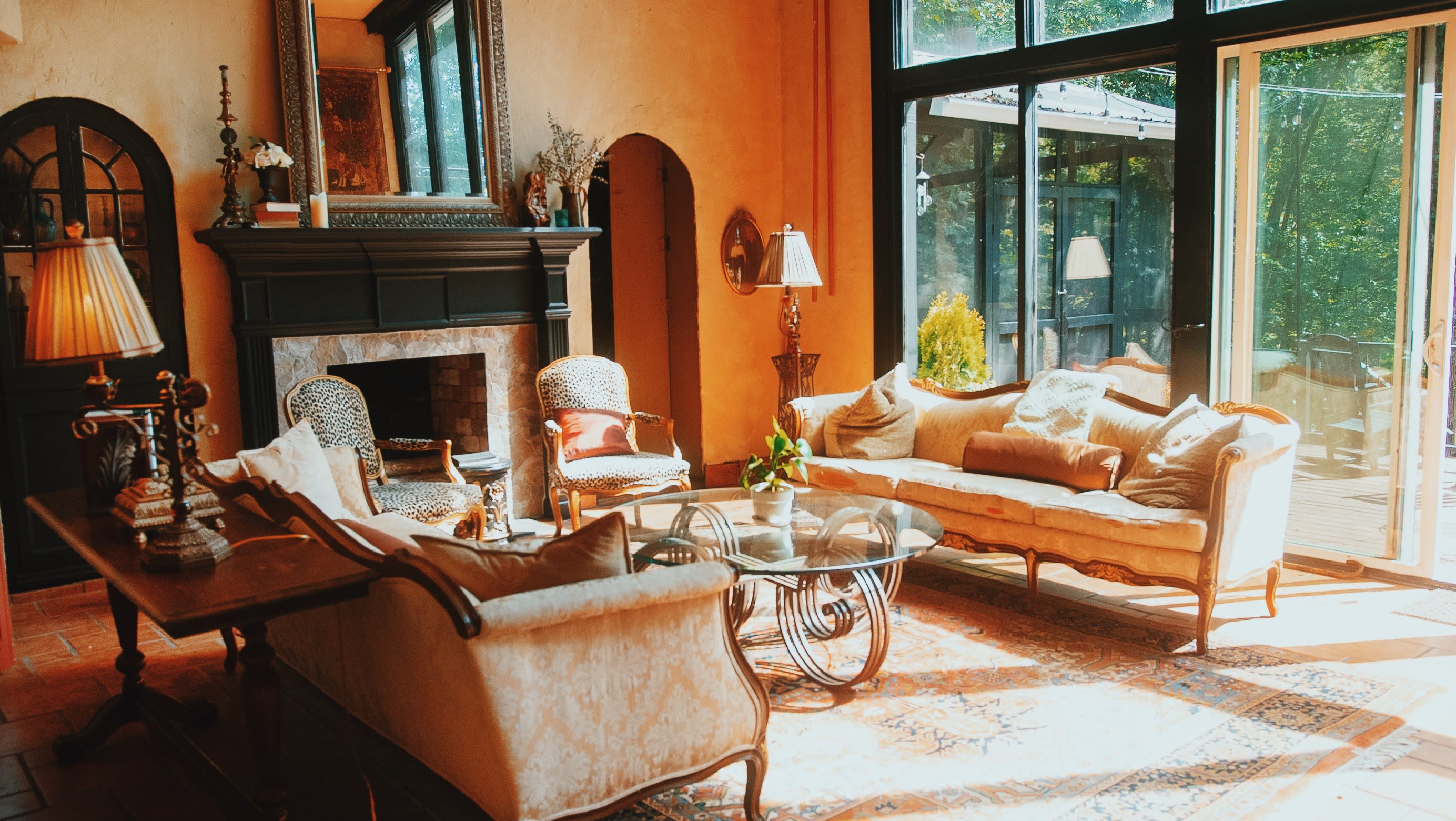 A photographer captures a model seated in a well-decorated room during a video shoot.