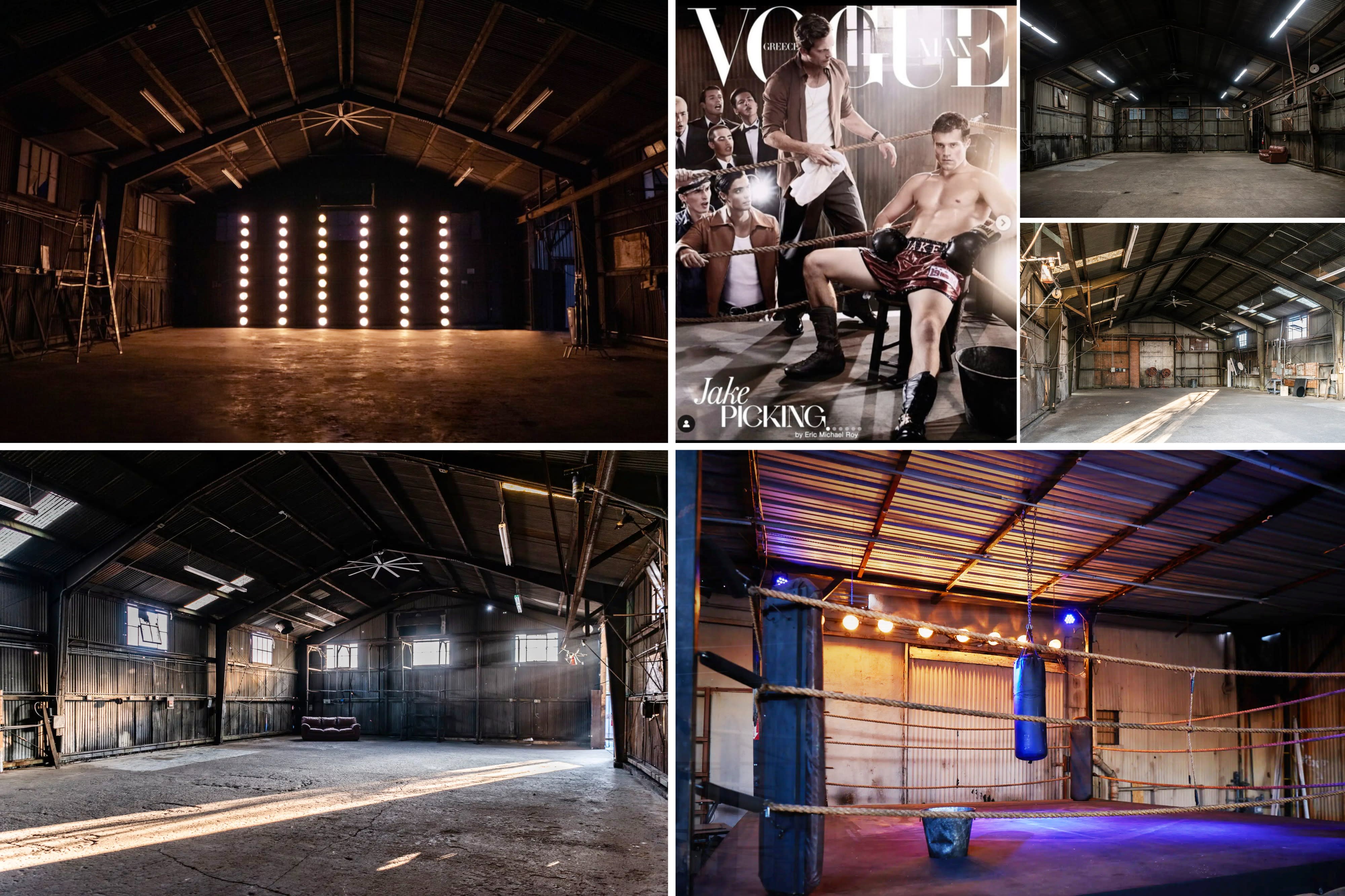 A dancer performs a handstand on a concrete floor in a well-lit industrial space.