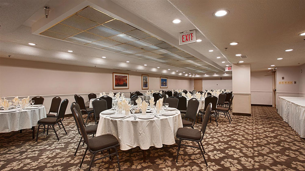 The image shows a decorated venue set for a private party, featuring themed tables with black and red decor, a variety of snacks, and festive arrangements.