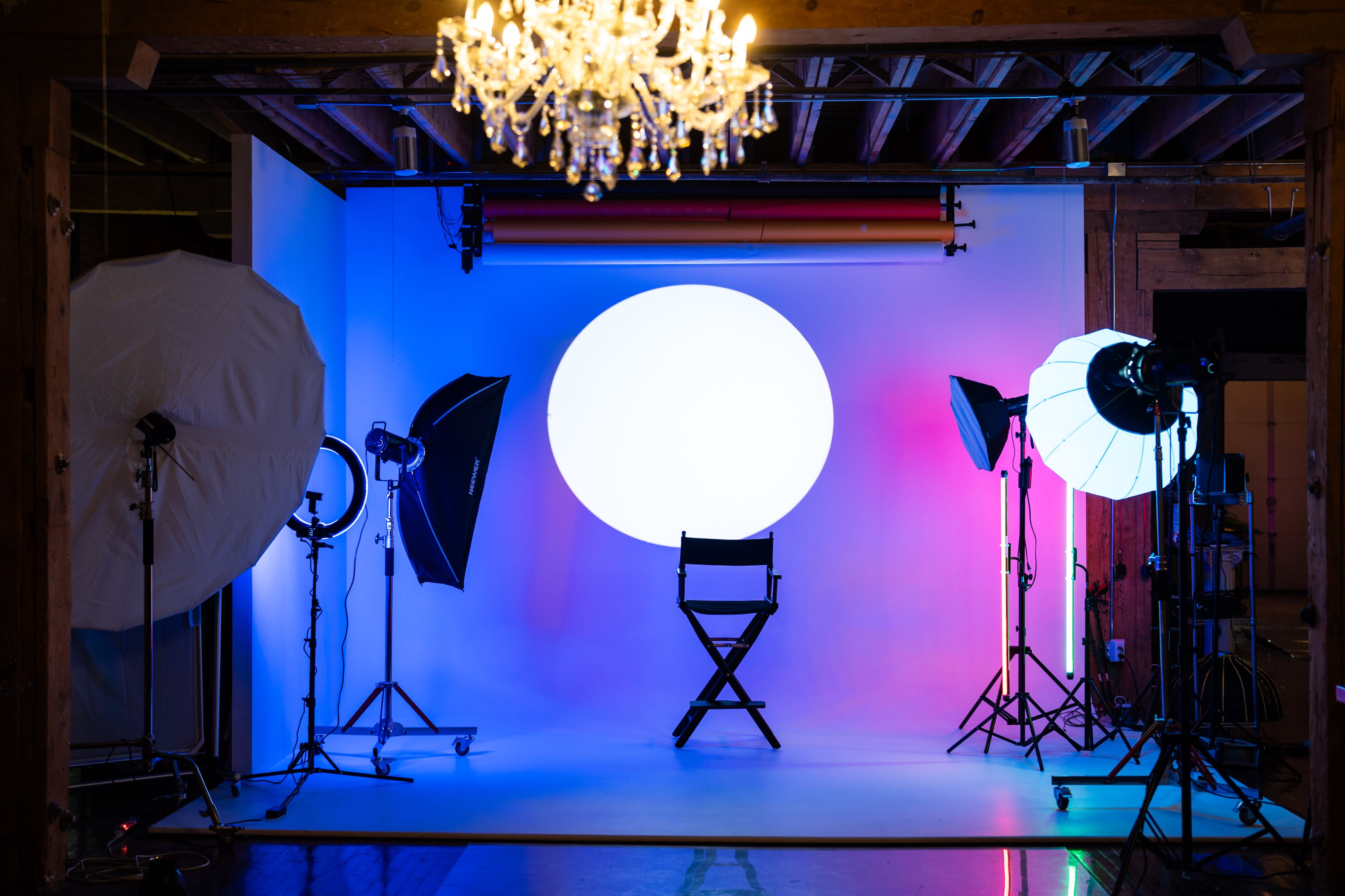 The image shows a group of four individuals posing in a studio setting, each wearing distinct outfits and styled in various creative themes.