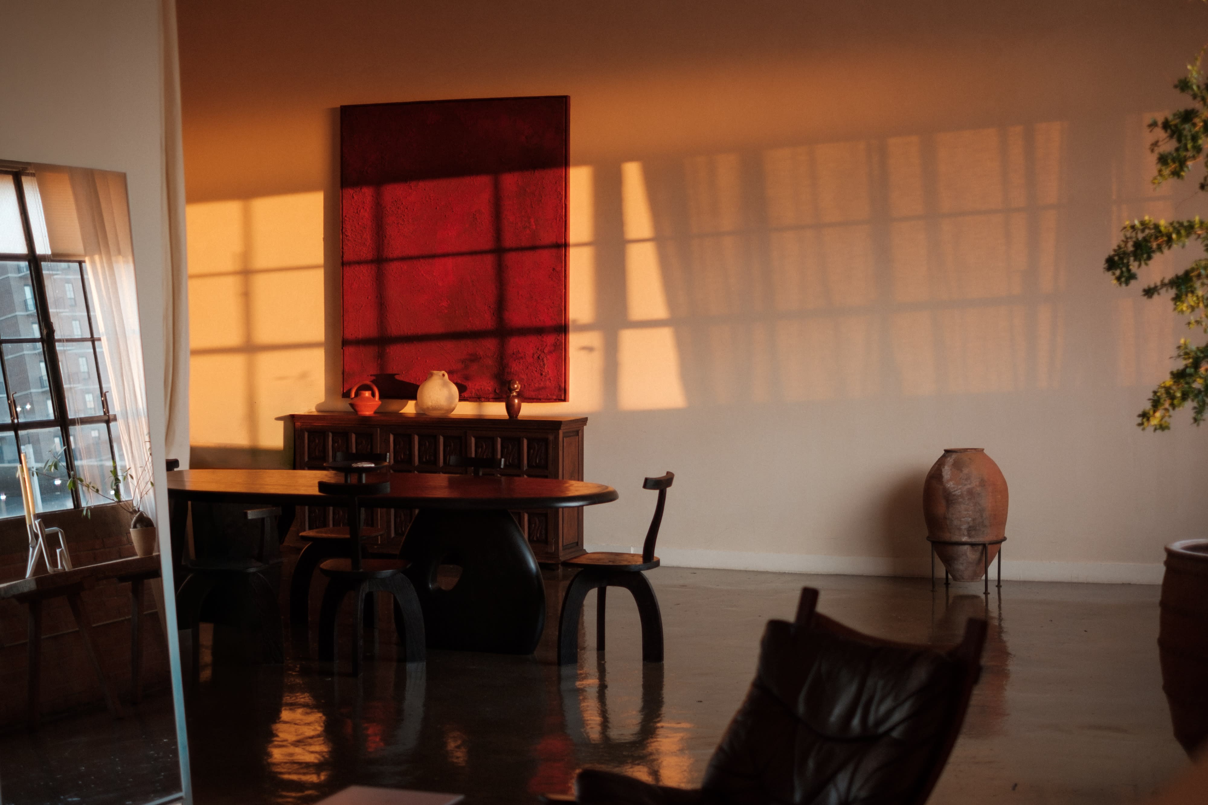 A photo shoot is taking place in an industrial-style room with large windows and polished floors.