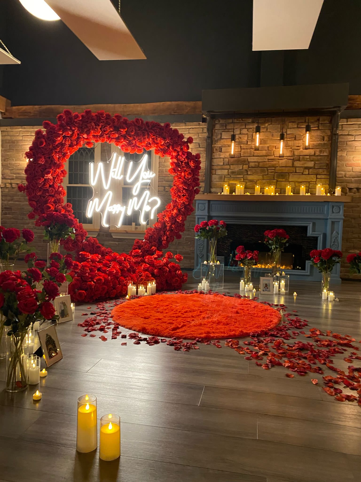The scene shows a stylishly decorated room for a 16th birthday celebration, featuring a large illuminated "16" sign, balloons, and a faux fireplace backdrop.